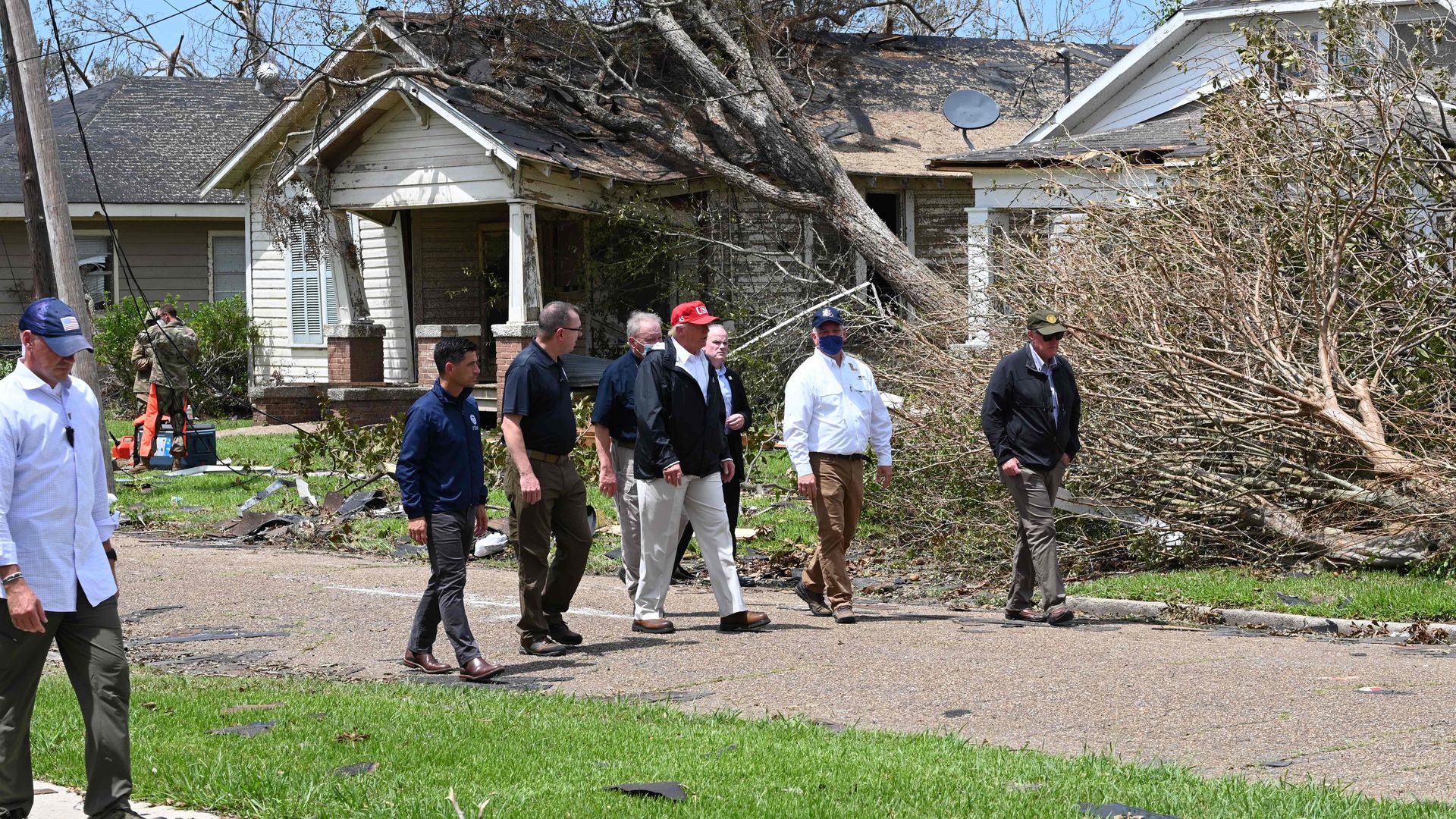 President Donald Trump (red cap) tours the damage caused by Hurricane Laura, in Lake Charles, Louisiana, on August 29