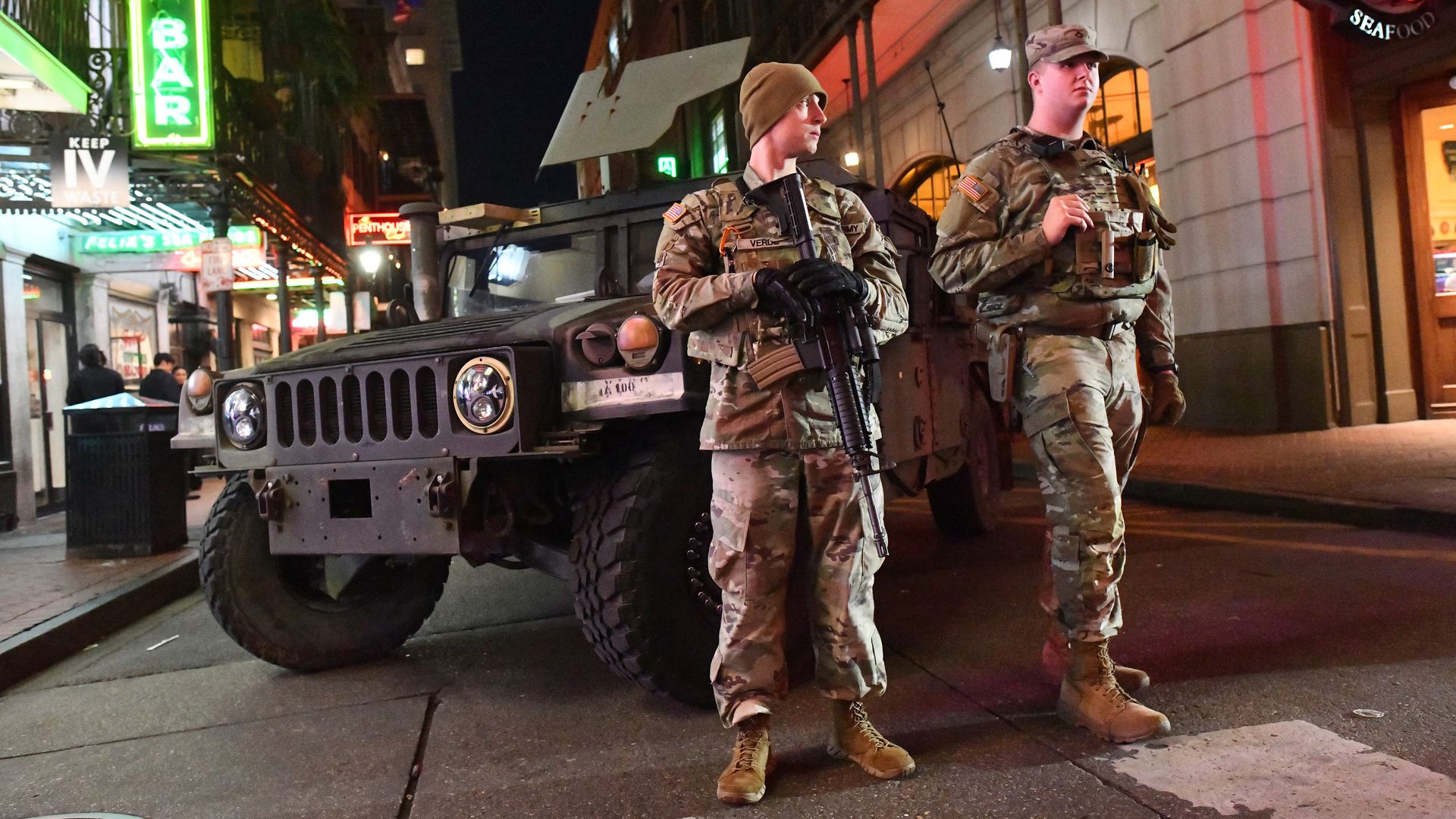 Photo shows National Guard soldiers with rifles on Bourbon Street.
