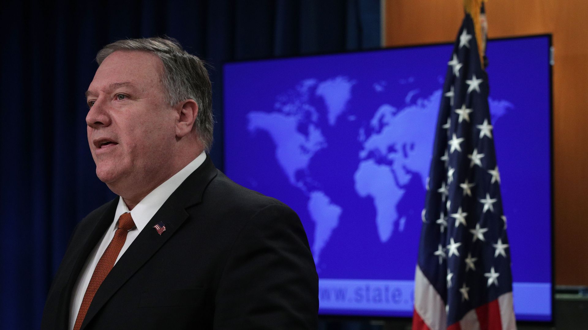 Mike Pompeo is pictured standing next to the American flag. 