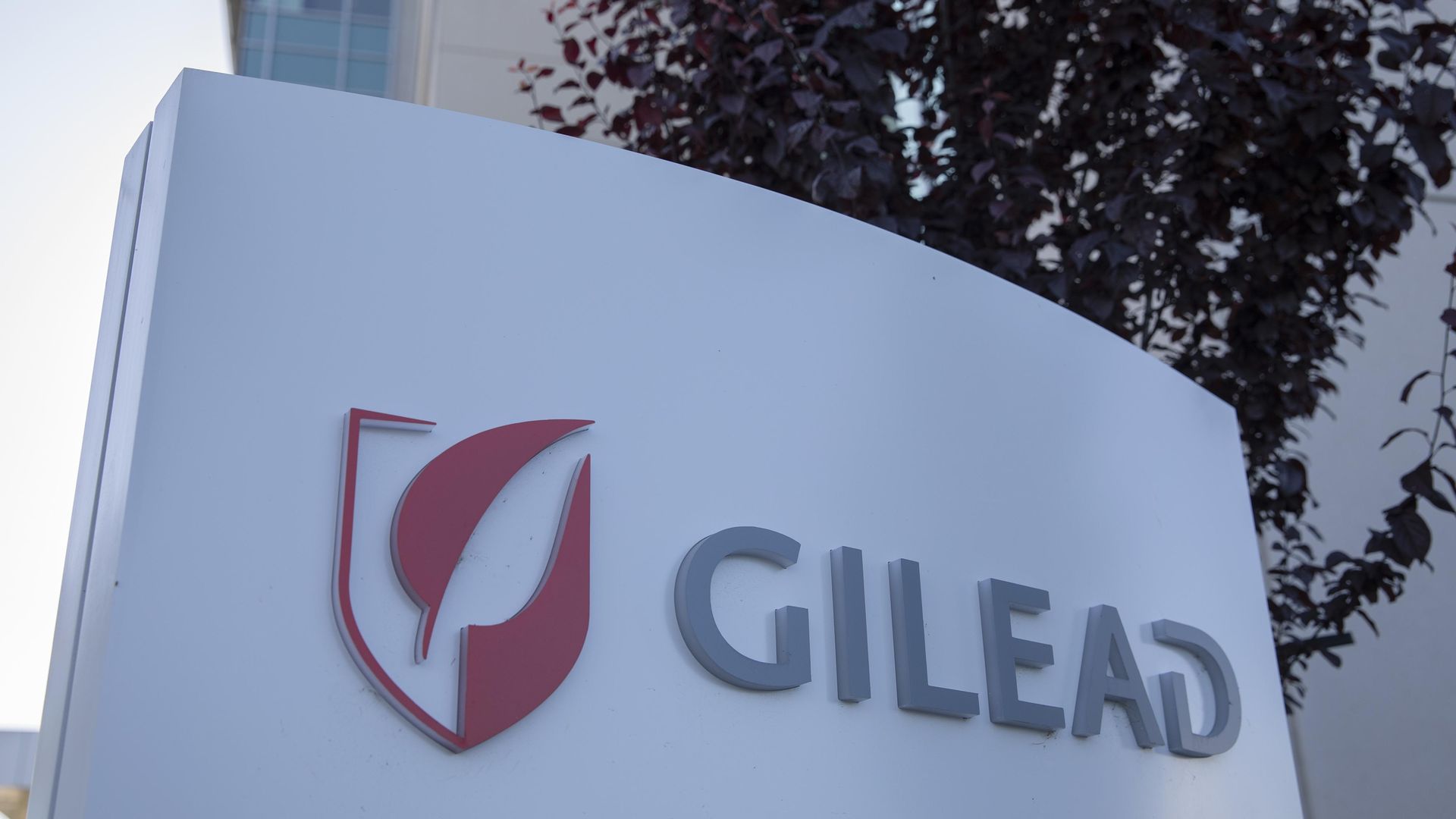 Gilead's white and red logo outside of its headquarters building.
