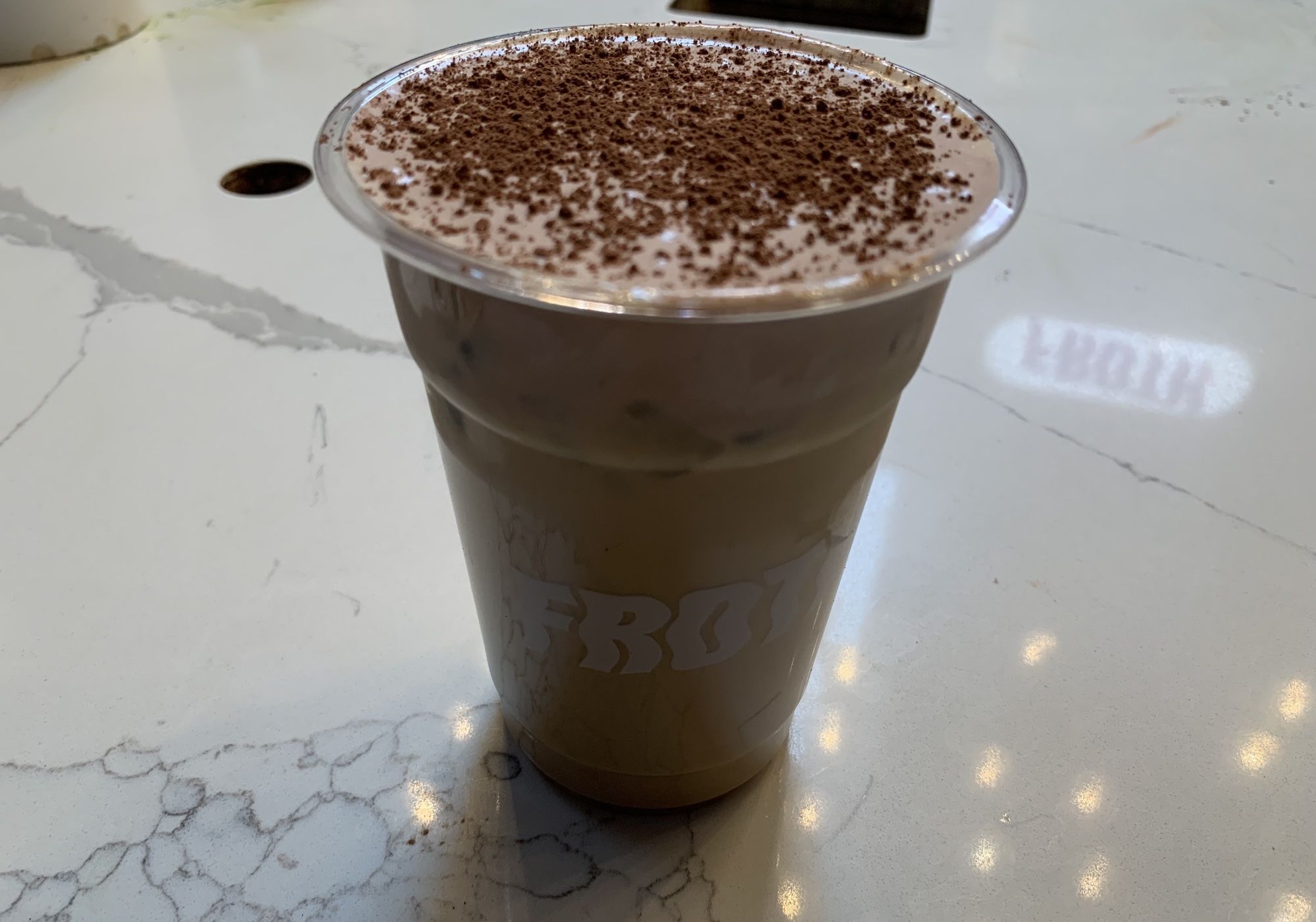 Coffee drink with chocolate flakes on top.