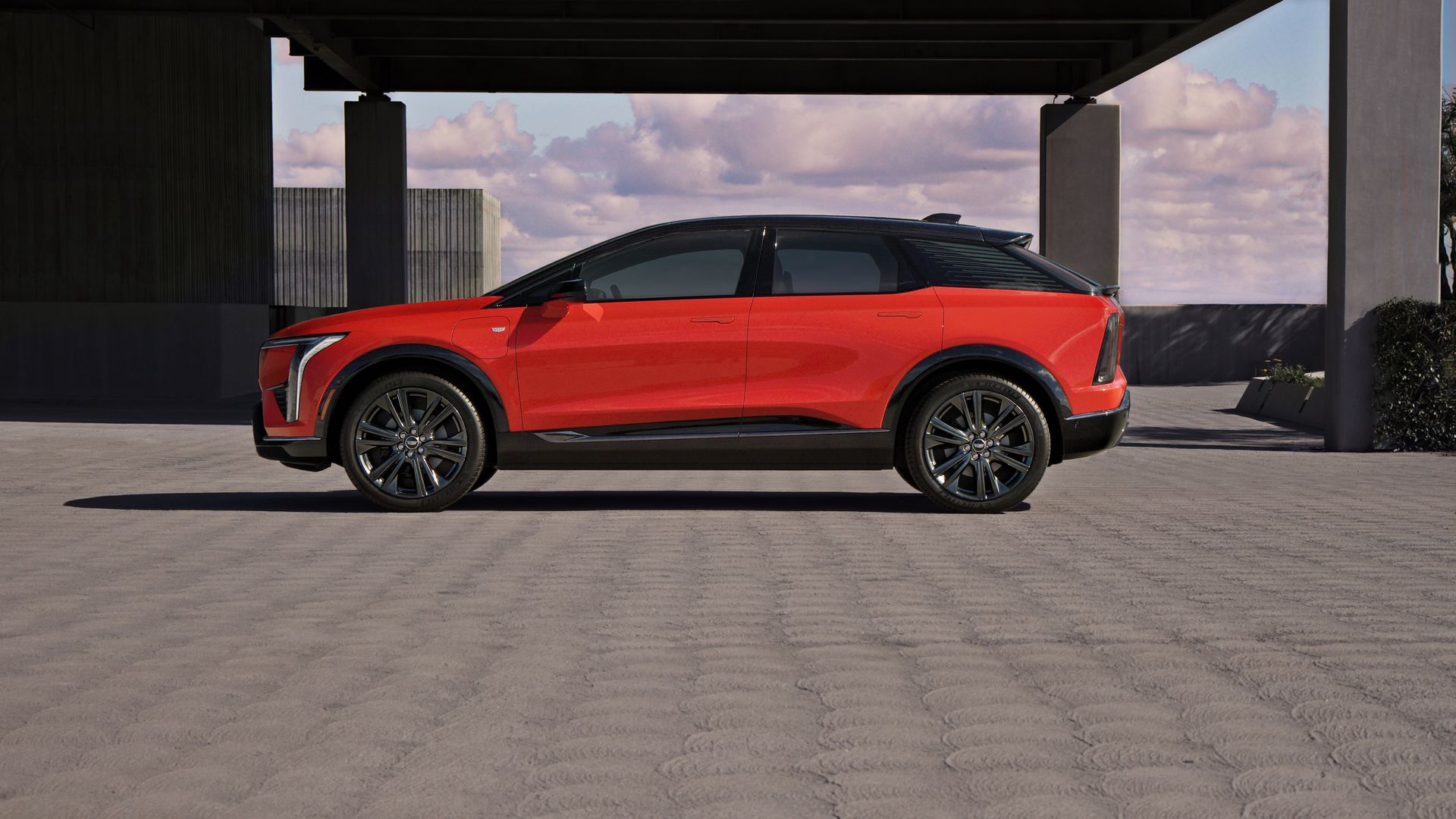 Image of the battery-electric Cadillac Optiq compact crossover SUV, in Monarch Orange.