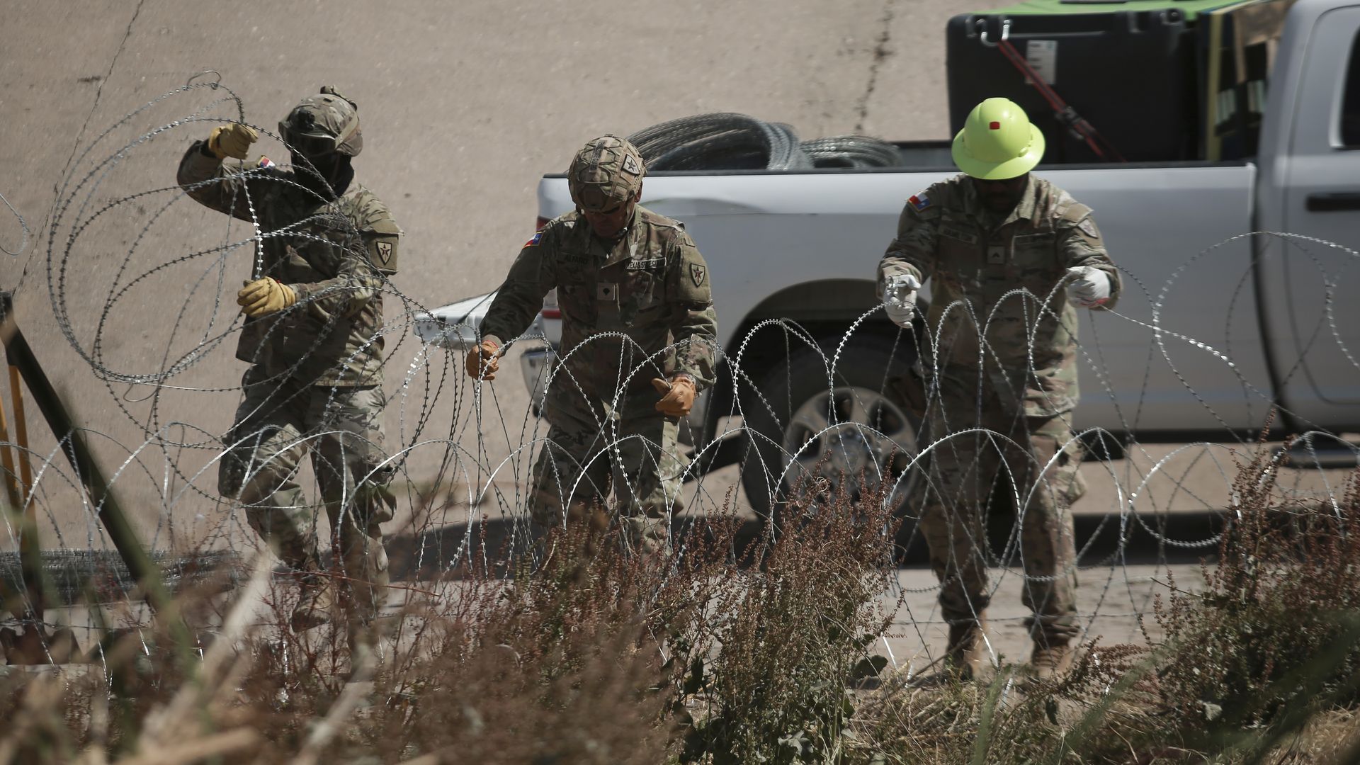 The Texas National Guard strengthens the barbed wire barriers along the Rio Grande along the border between Ciudad Juarez and El Paso, Texas, on May 6, 2025. 