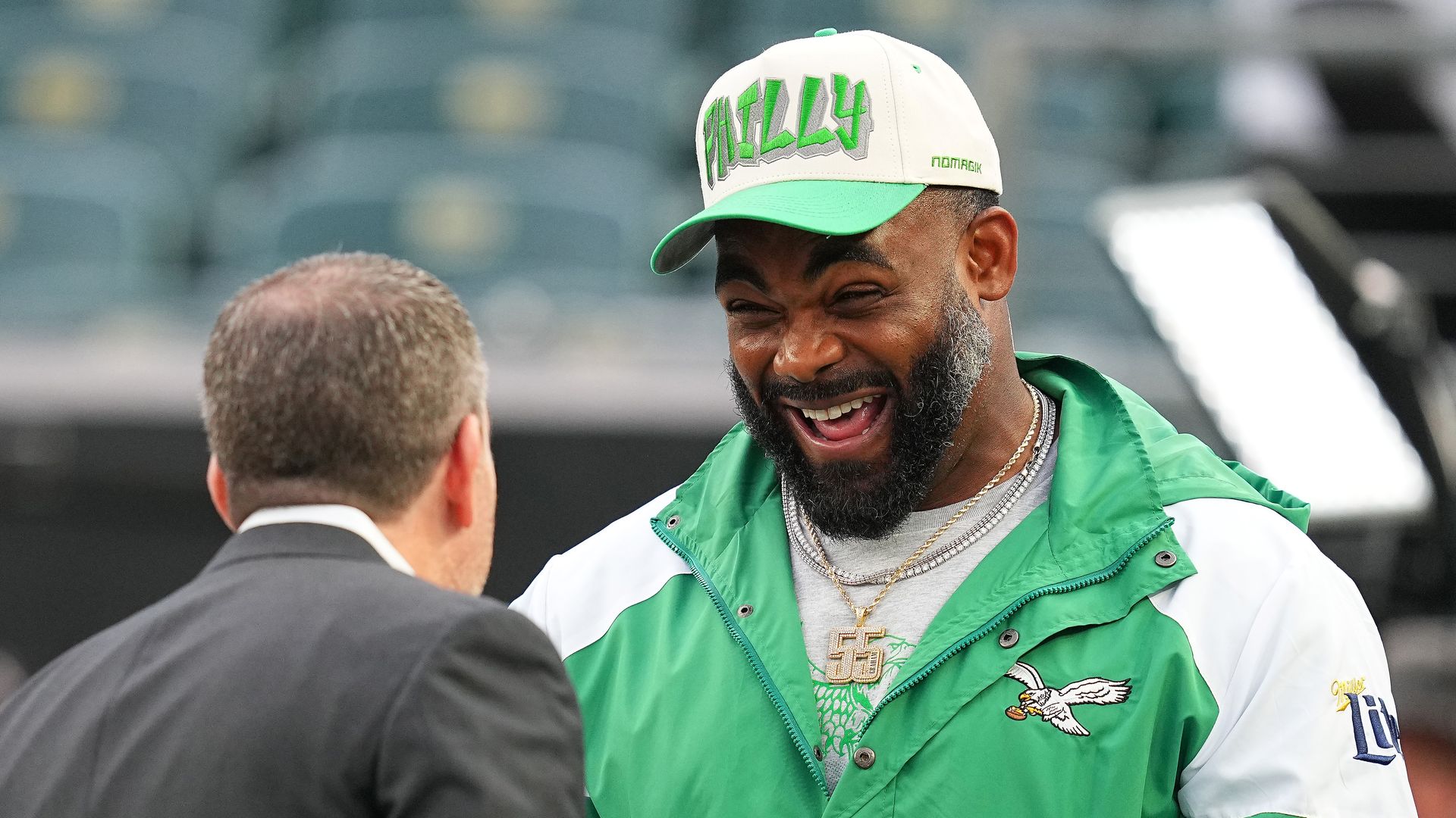 Former Philadelphia Eagles player Brandon Graham talking with team general manager Howie Roseman.