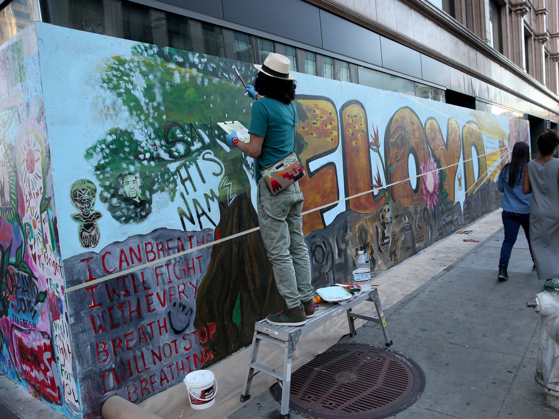 George Floyd murals painted on Apple and Louis Vuitton stores in