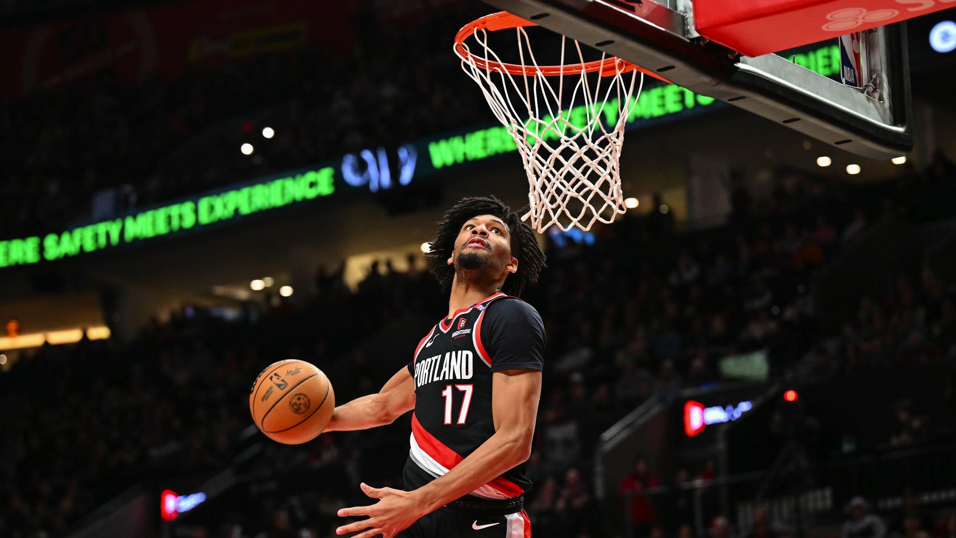 Guard Shaedon Sharpe of the Portland Trail Blazers goes up for a dunk in an NBA game.
