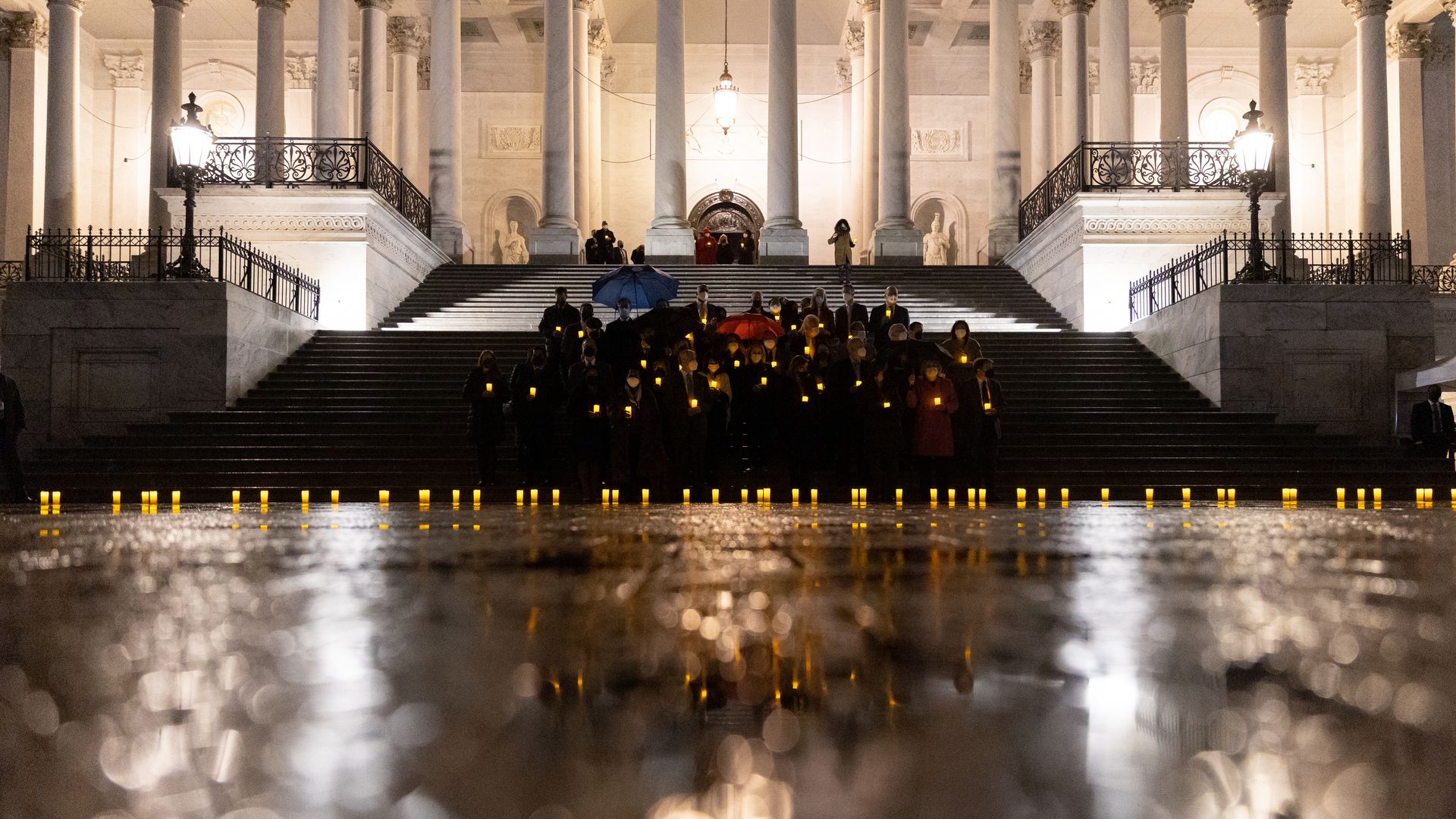 Members of Congress participate in a moment of silence for the 900,000 American lives lost to Covid-19 on the steps of the U.S. Capitol in Washington, D.C., U.S., on Monday, Feb. 7, 2022.