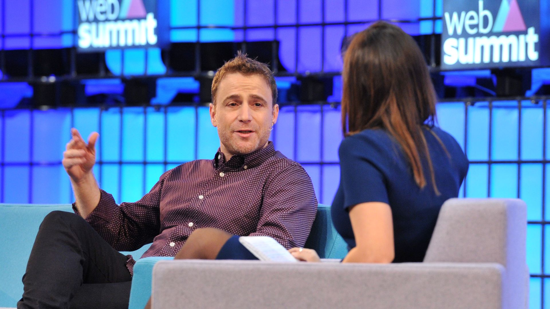 Photo of Slack CEO Stewart Butterfield speaking on conference stage.