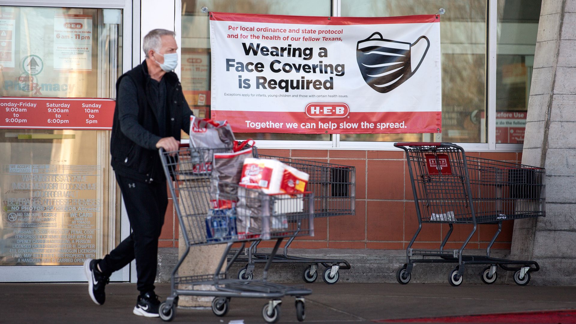 A customer leaves H-E-B on March 3, 2021 in Austin, Texas. The popular Texas supermarket chain will not require customers to wear masks when the statewide mask mandate