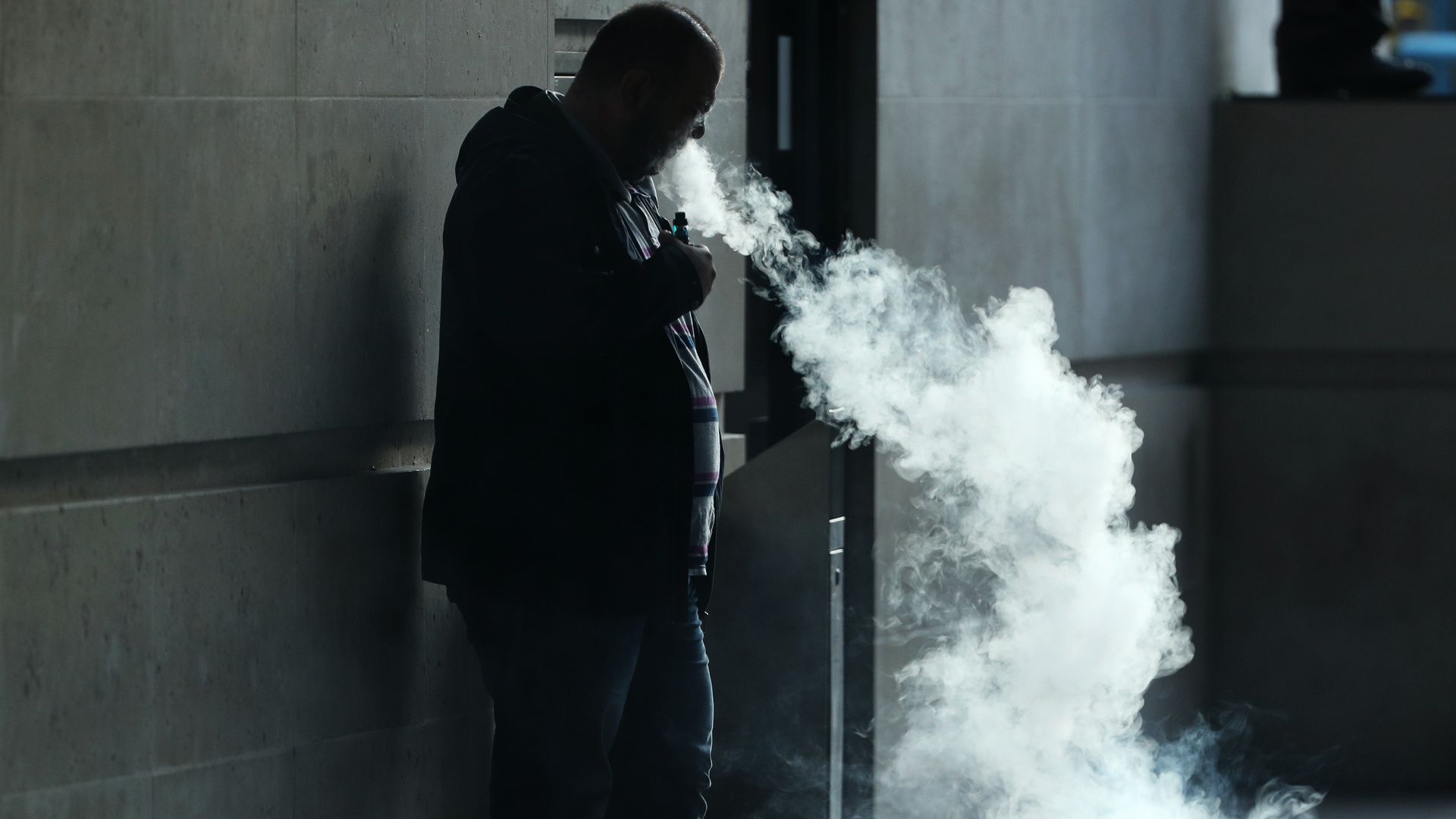 A man smokes an e-cigarette.