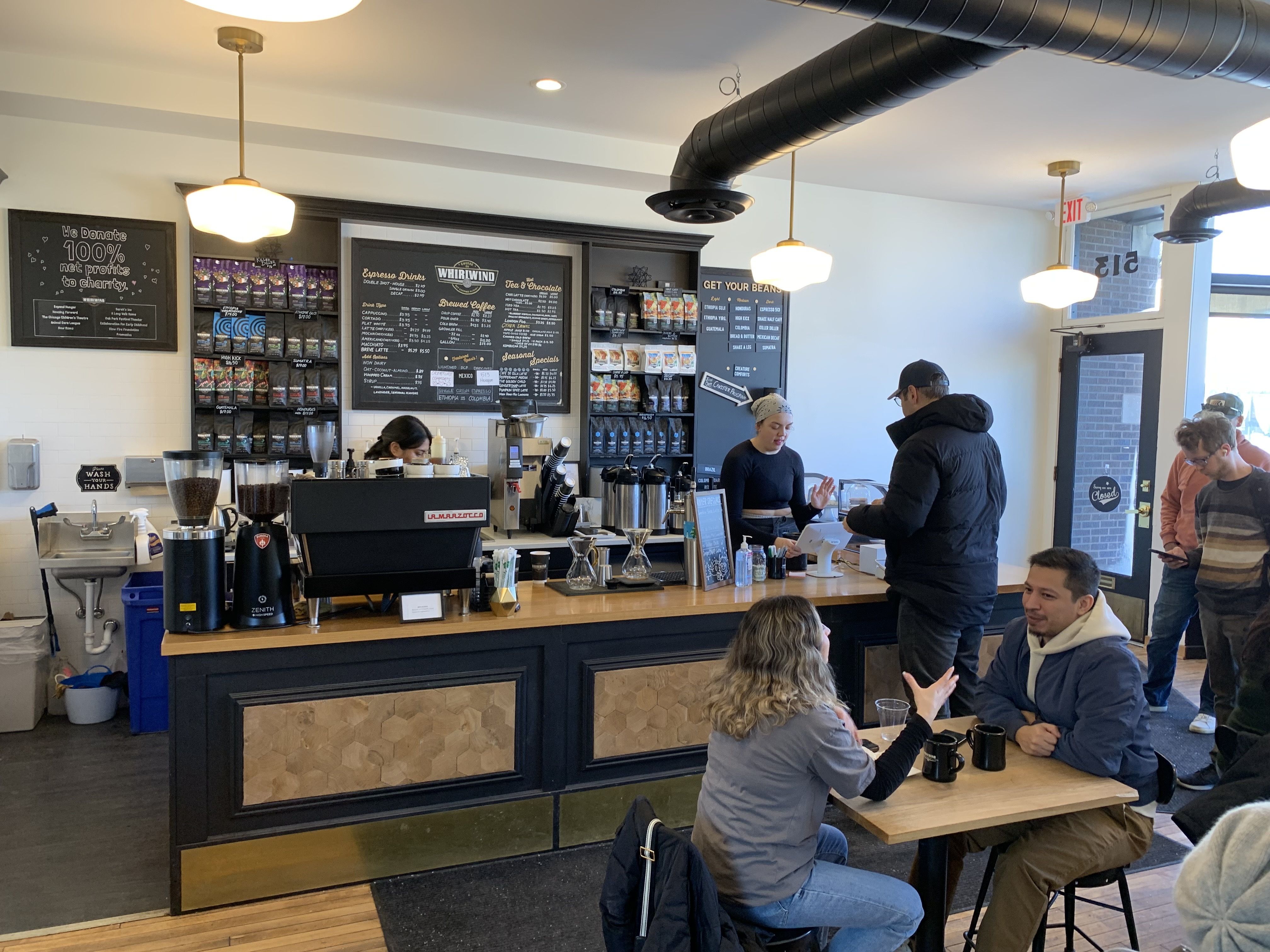 Photo of a coffee shop as customers wait in line 