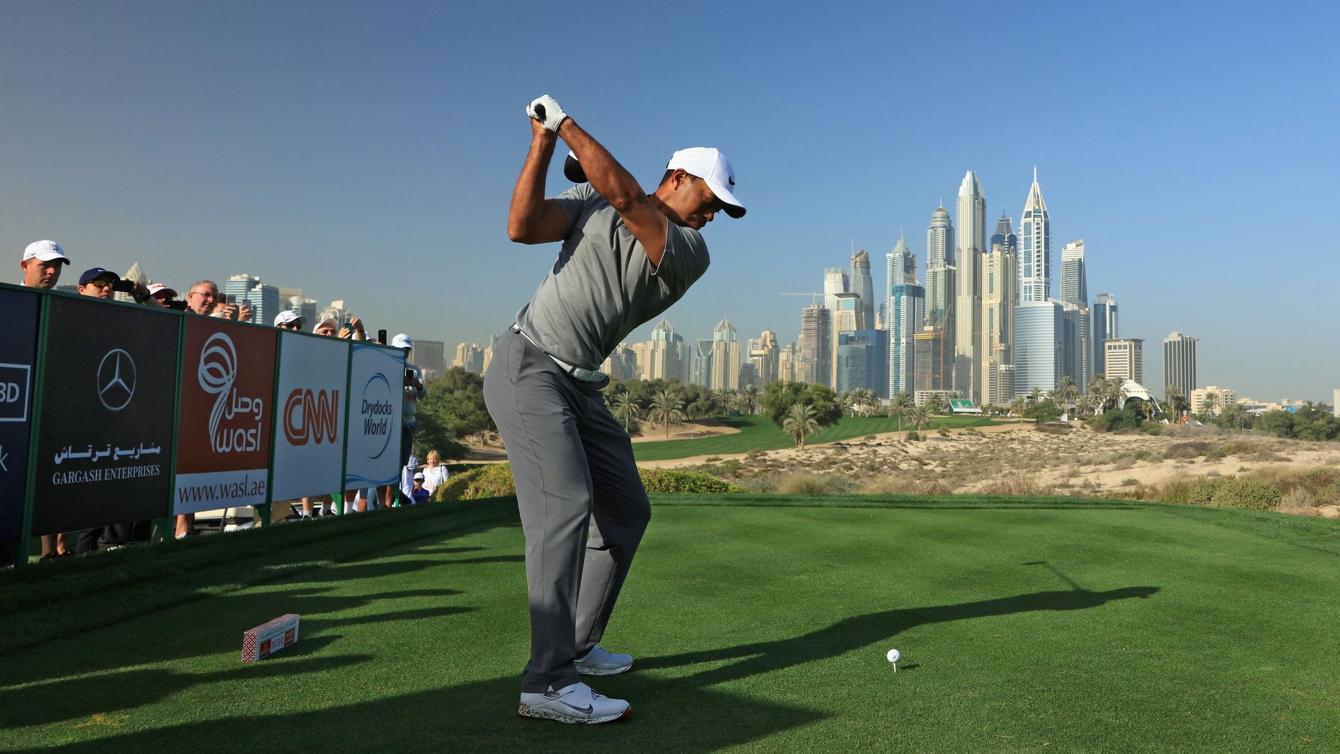 Tiger Woods teeing off at Dubai's Emirates Golf Club in 2017. Photo: David Cannon/Getty Images