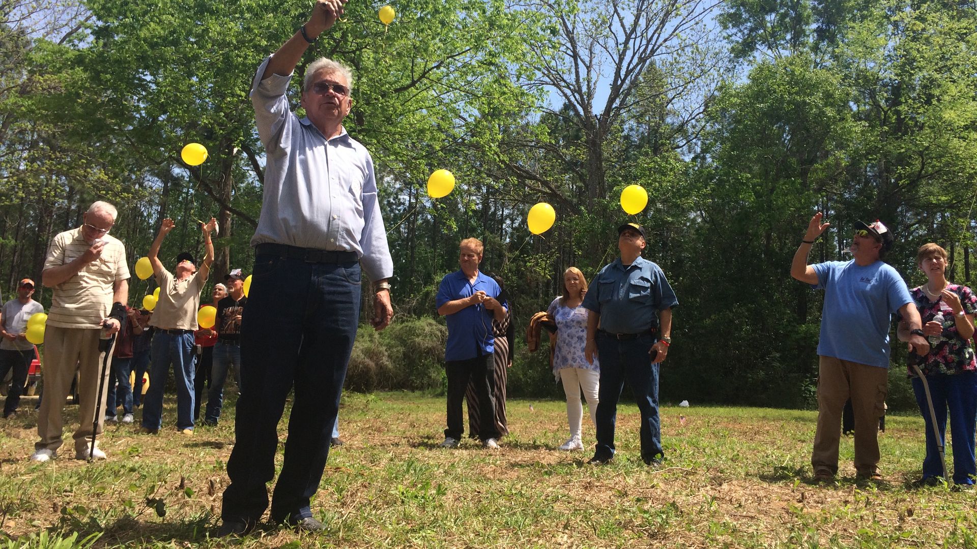Former wards of the state who call themselves the White House Boys release yellow balloons in memory of boys who died at the state-run reform school.