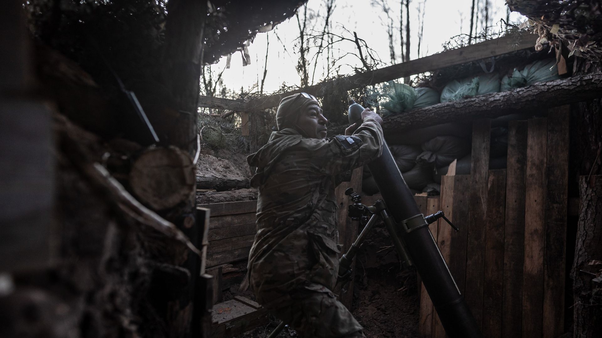 Ukrainian solider in foxhole with mortar