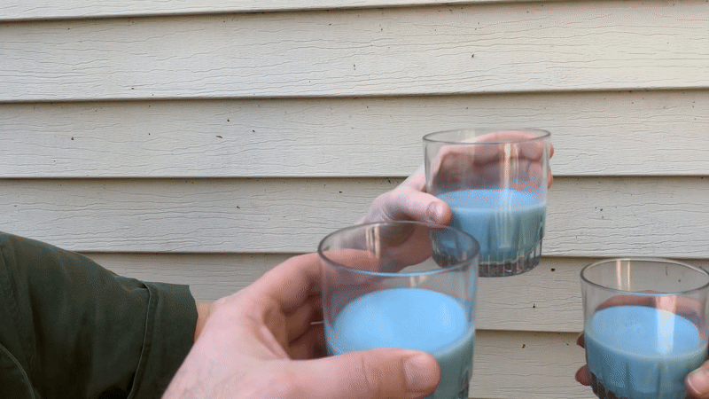 GIF of a toast using three glasses of blue milk 