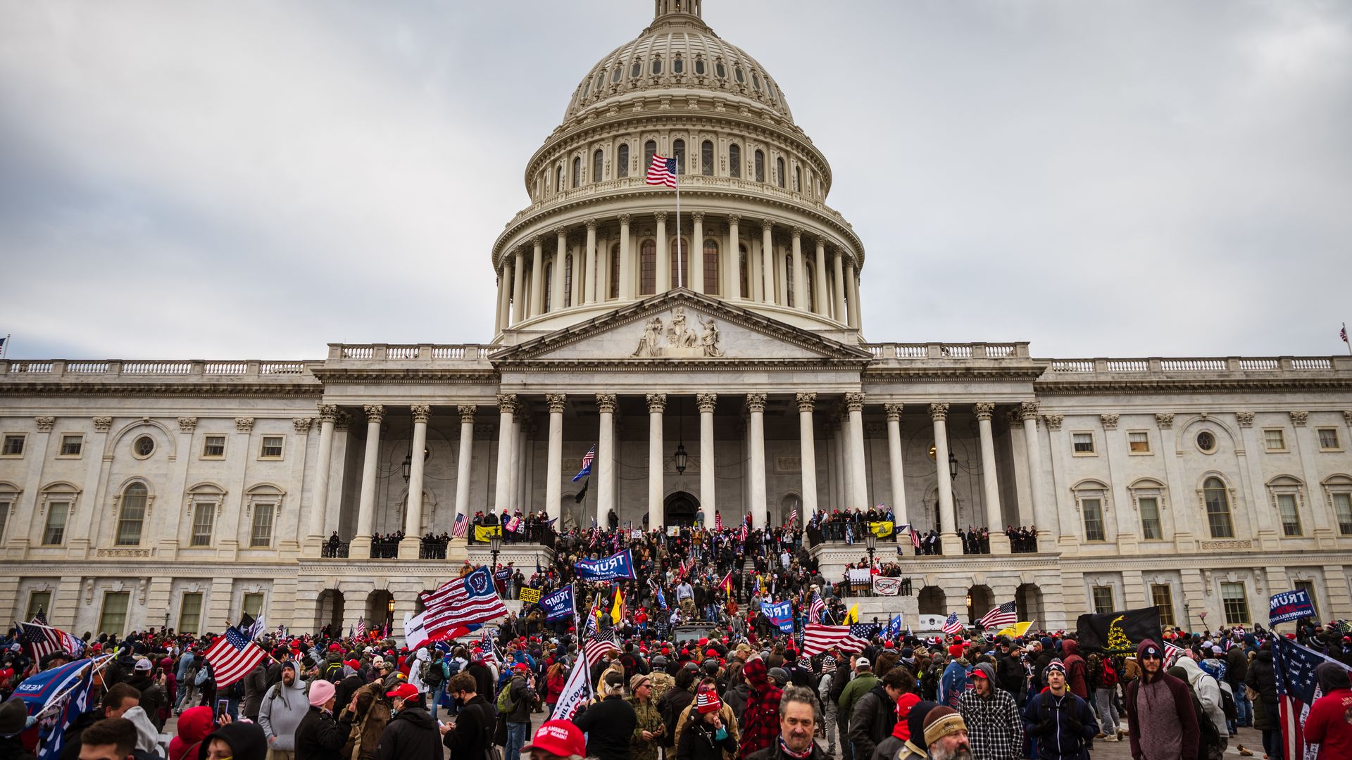  A large group of pro-Trump protesters stand on the East steps of the Capitol Building after storming its grounds on January 6, 2021 in Washington, DC. 