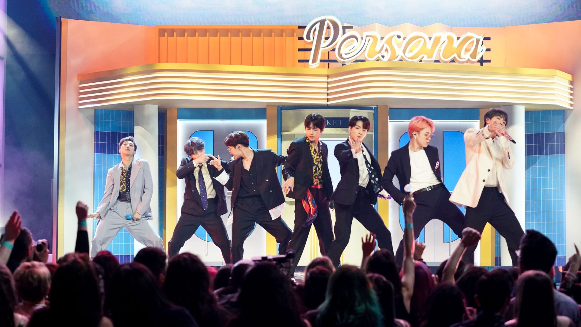 Seven people on stage, singing