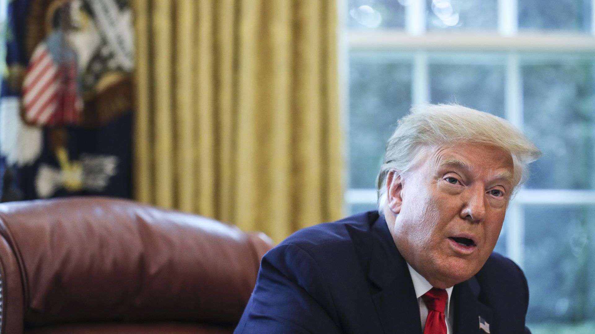 Trump sits in the Oval Office