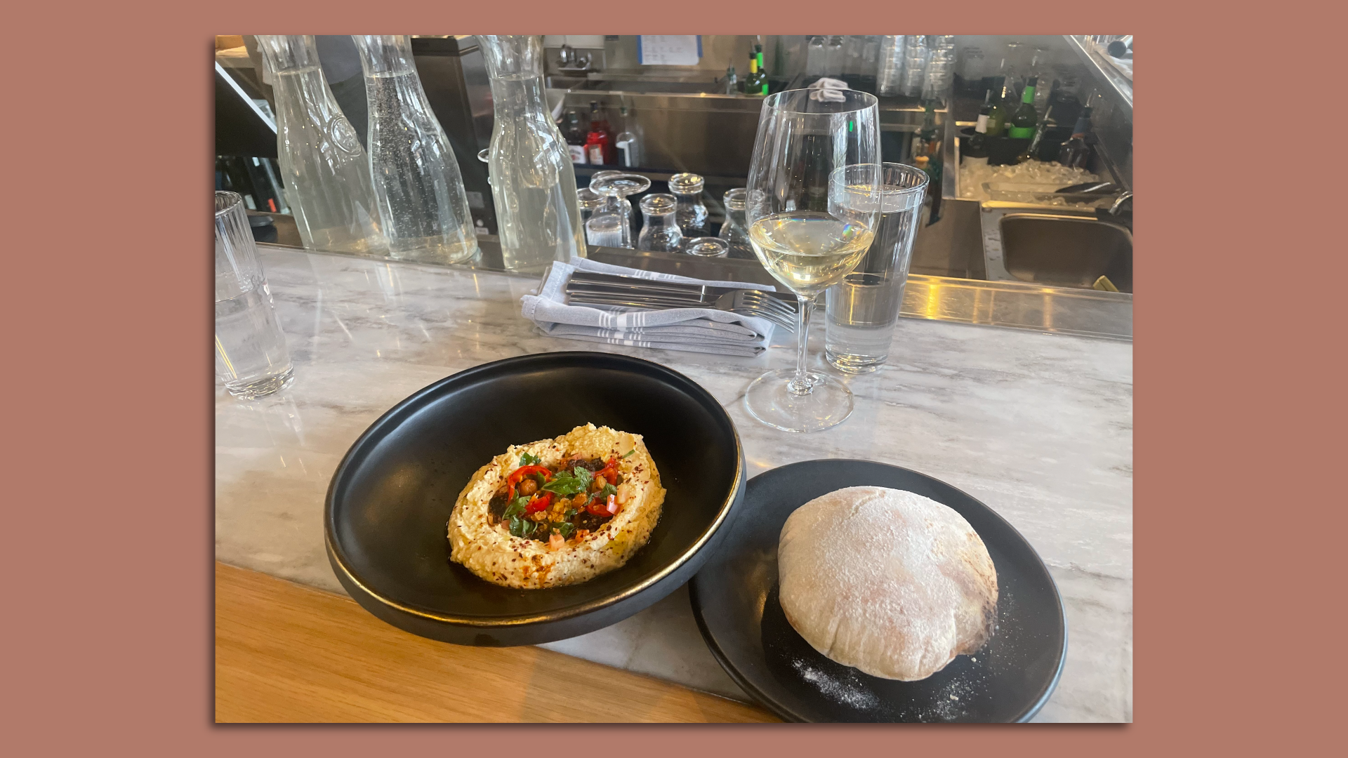 pita, hummus and a glass of white wine
