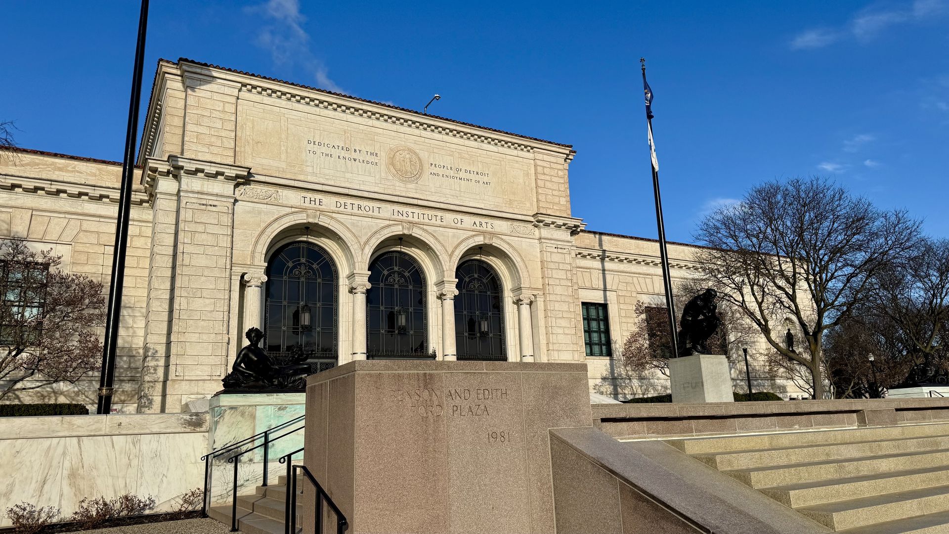 Beige stone façade of Detroit Institute of Arts, with arched windows and carved inscription