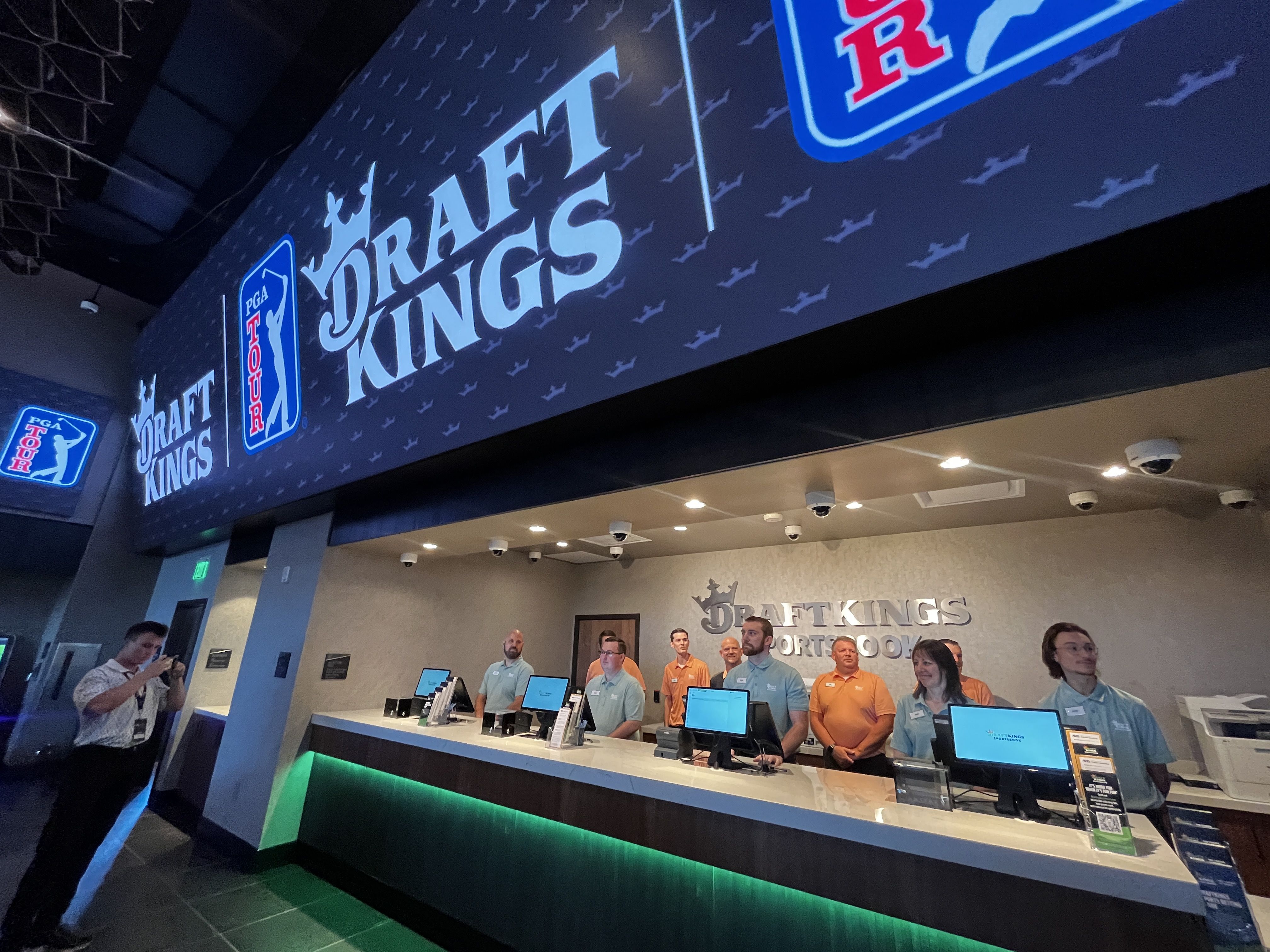 People standing at betting windows.