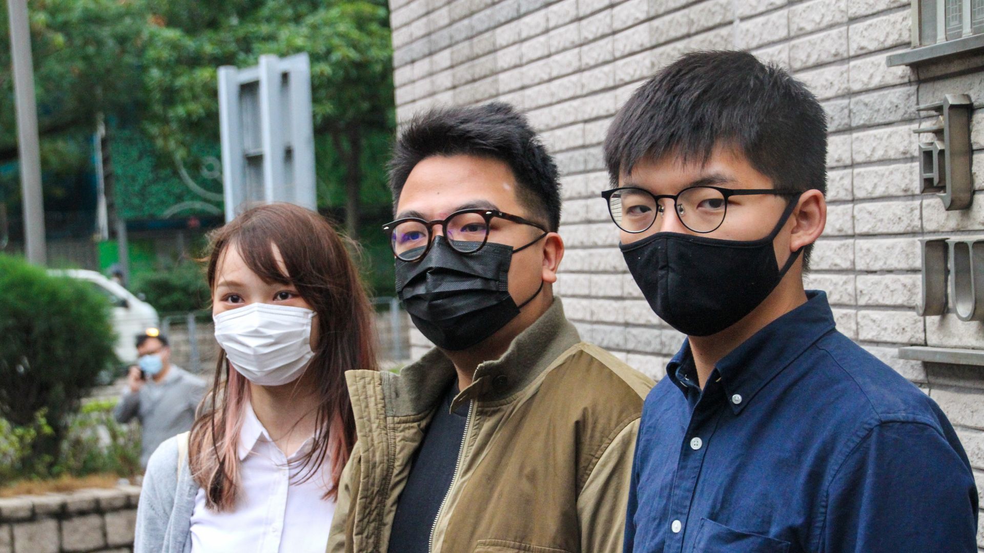 Hong Kong activists Agnes Chow (left), Ivan Lam (centre) and Joshua Wong (right) attend court facing charges of illegal assembly from the citys protests in 2019