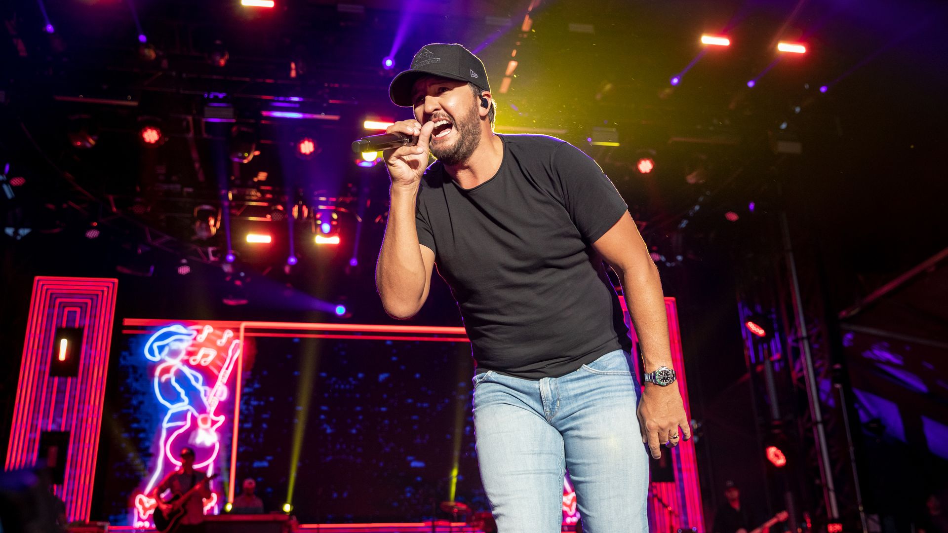 Luke Bryan singing into a microphone 