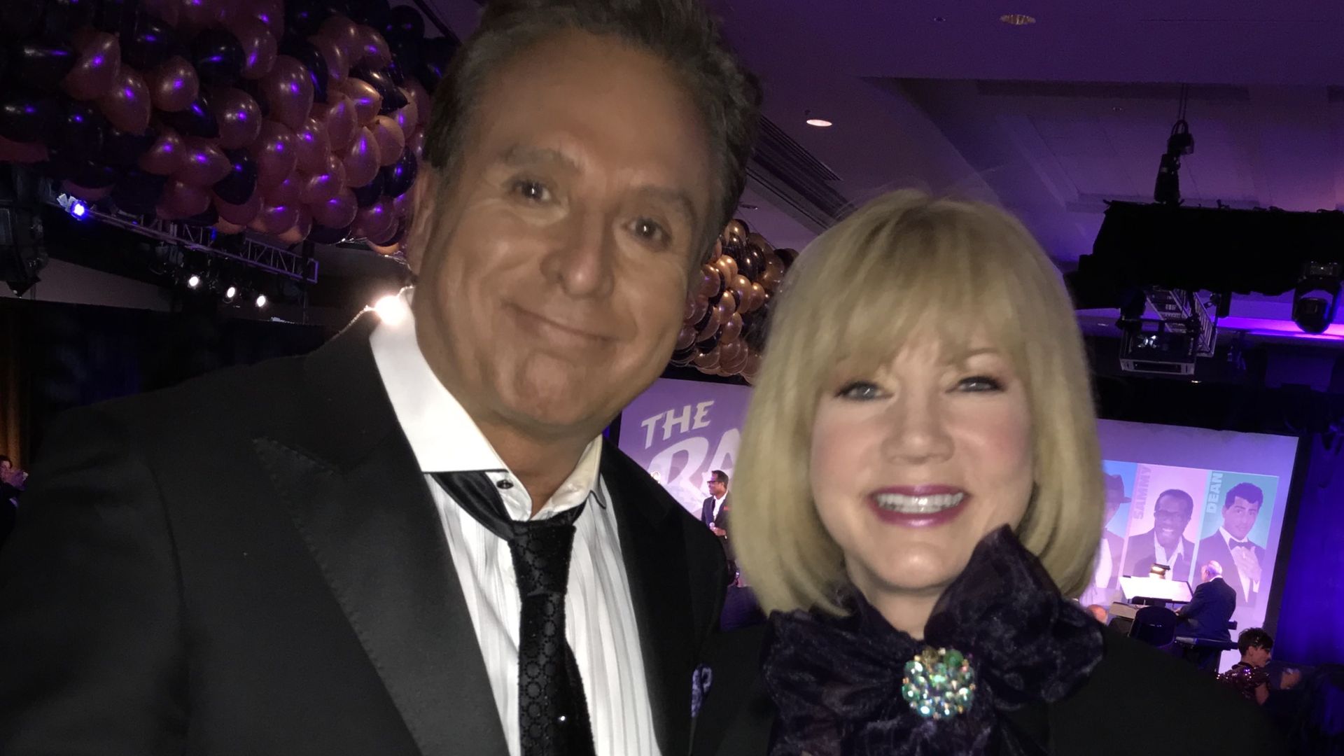 A photo of two people dressed up and dancing.