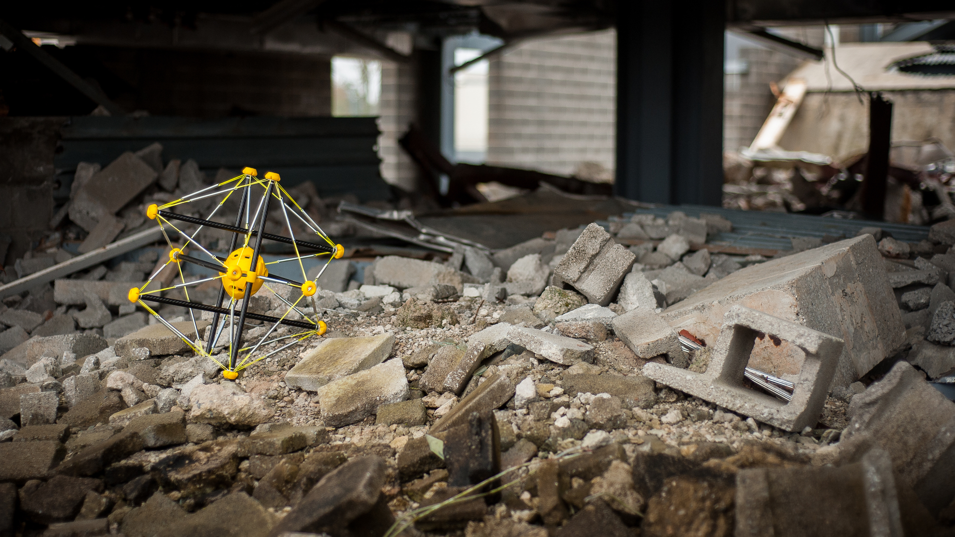 Photo of a small spherical robot among rubble
