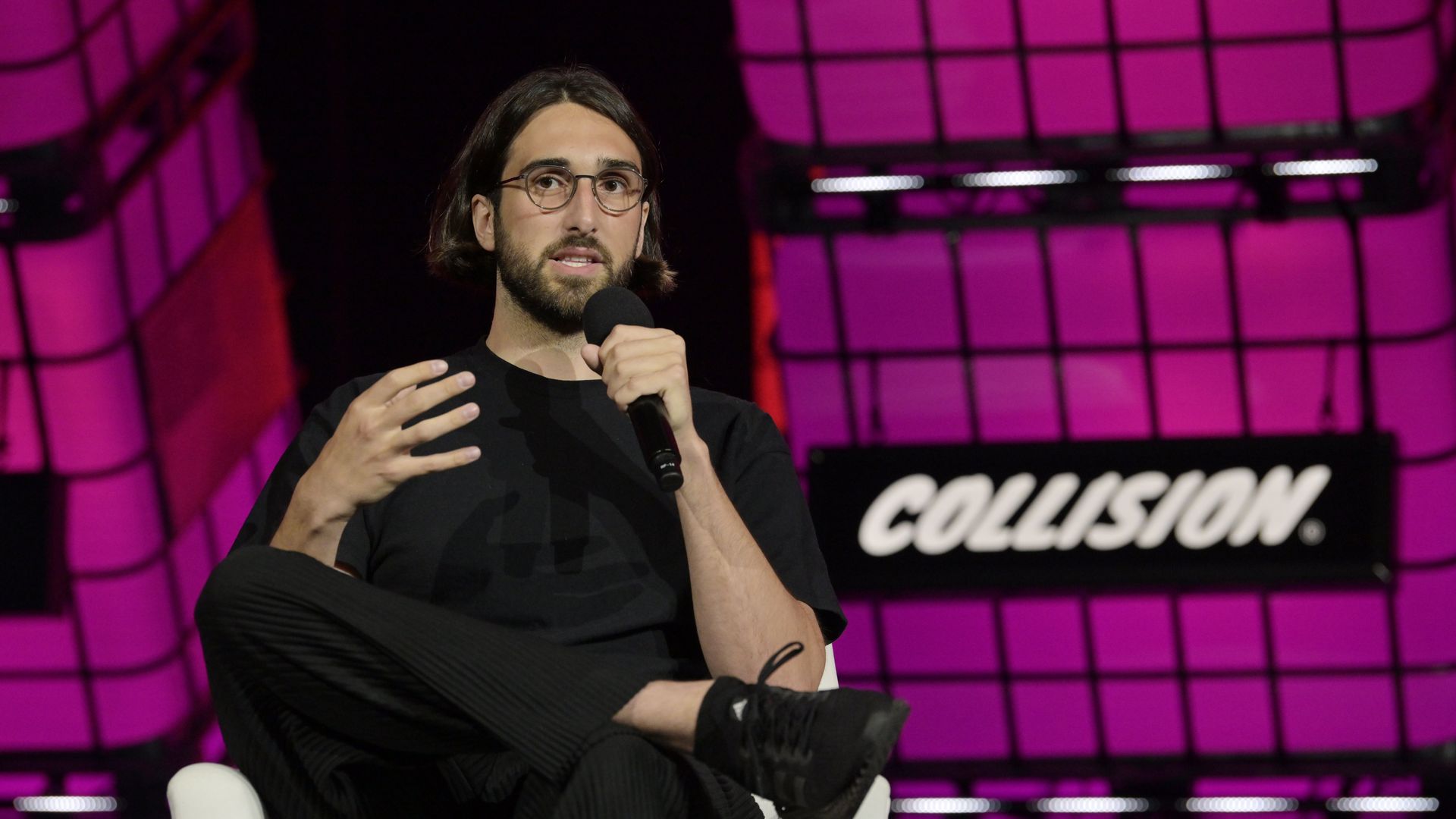 Cohere co-founder Aidan Gomez speaking on stage at the Collision conference in Toronto, Canada