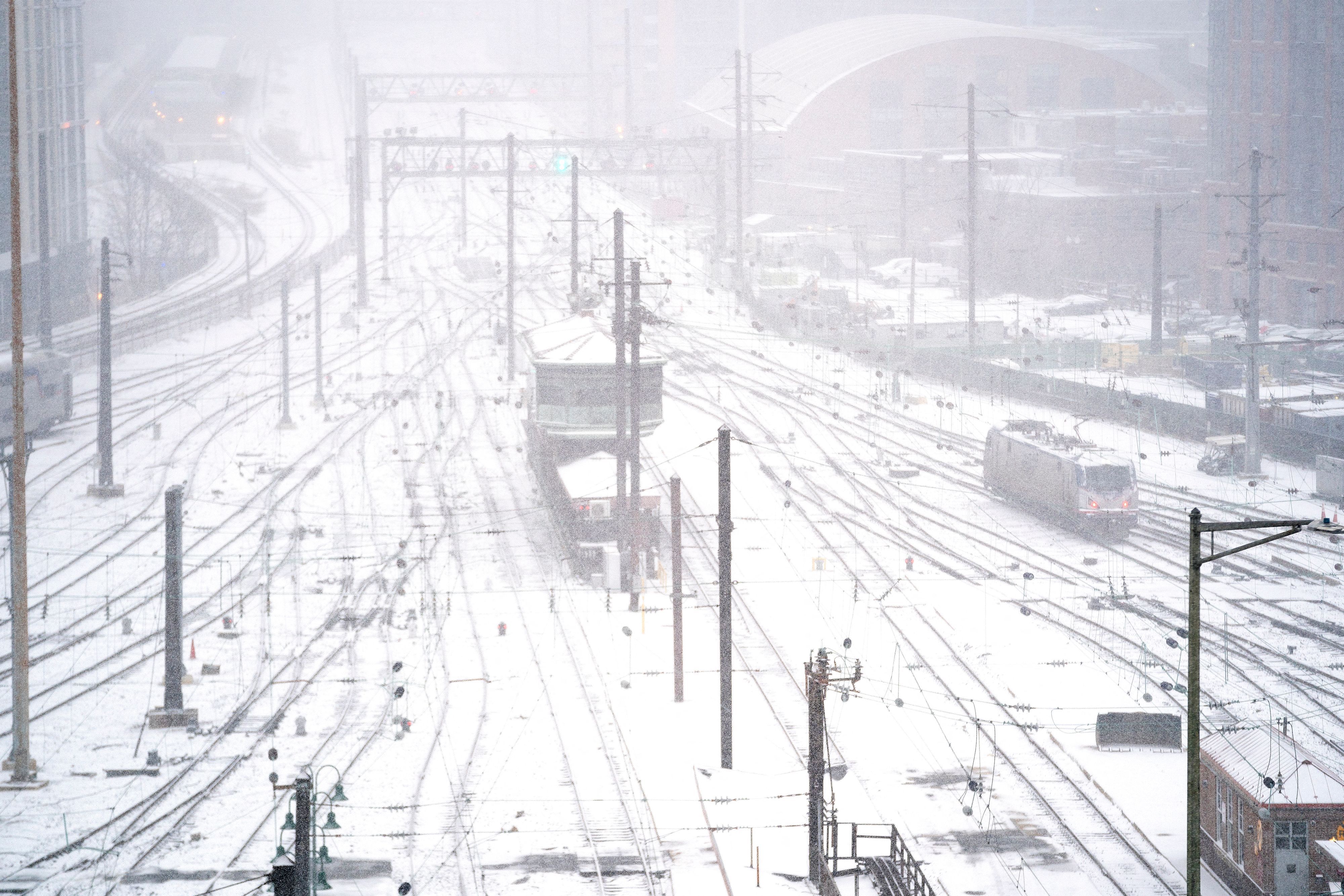 An Amtrak train engine moves along tracks in the train yard at Union Station in Washington, DC, during a winter storm on January 16.