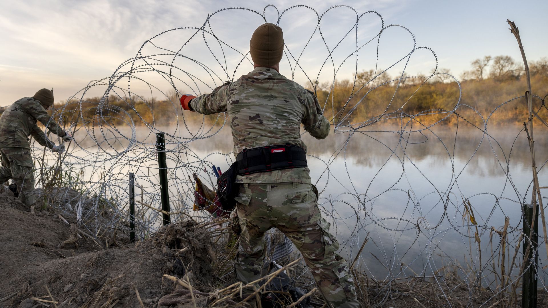 Texas National Guard soldiers install additional razor wire lie along the Rio Grande on January 10, 2024 in Eagle Pass, Texas. 