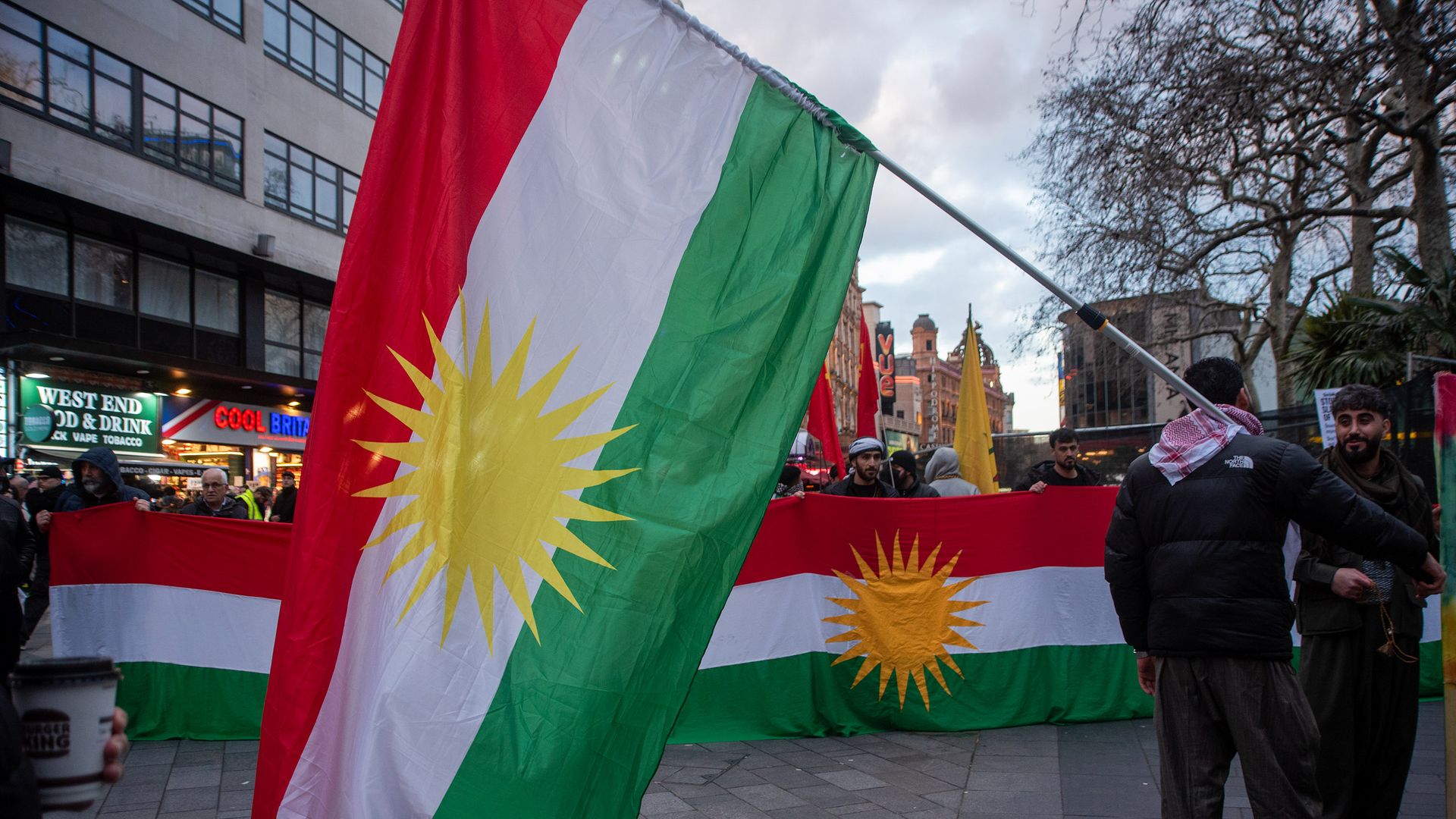 A protester holds a Kurdish flag during a demonstration in London's Leicester Square on Jan. 28, 2026. Photo: Krisztian Elek/SOPA Images/LightRocket via Getty Images