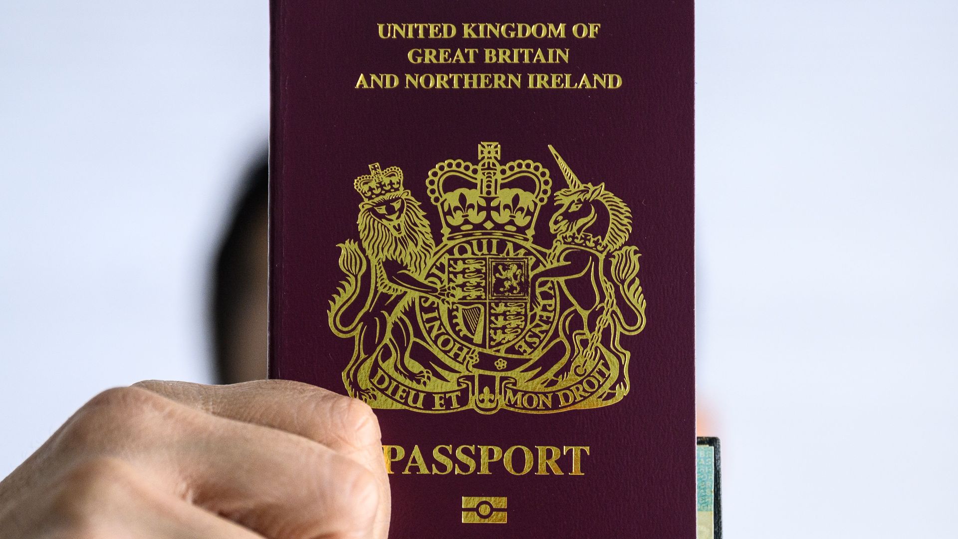 A person holds up a British National (Overseas) passport in Hong Kong