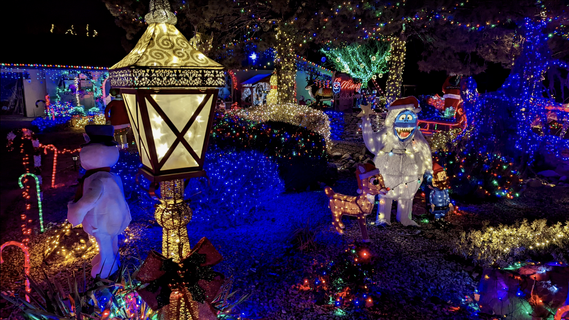 An elaborate christmas lights display outside a person's house.