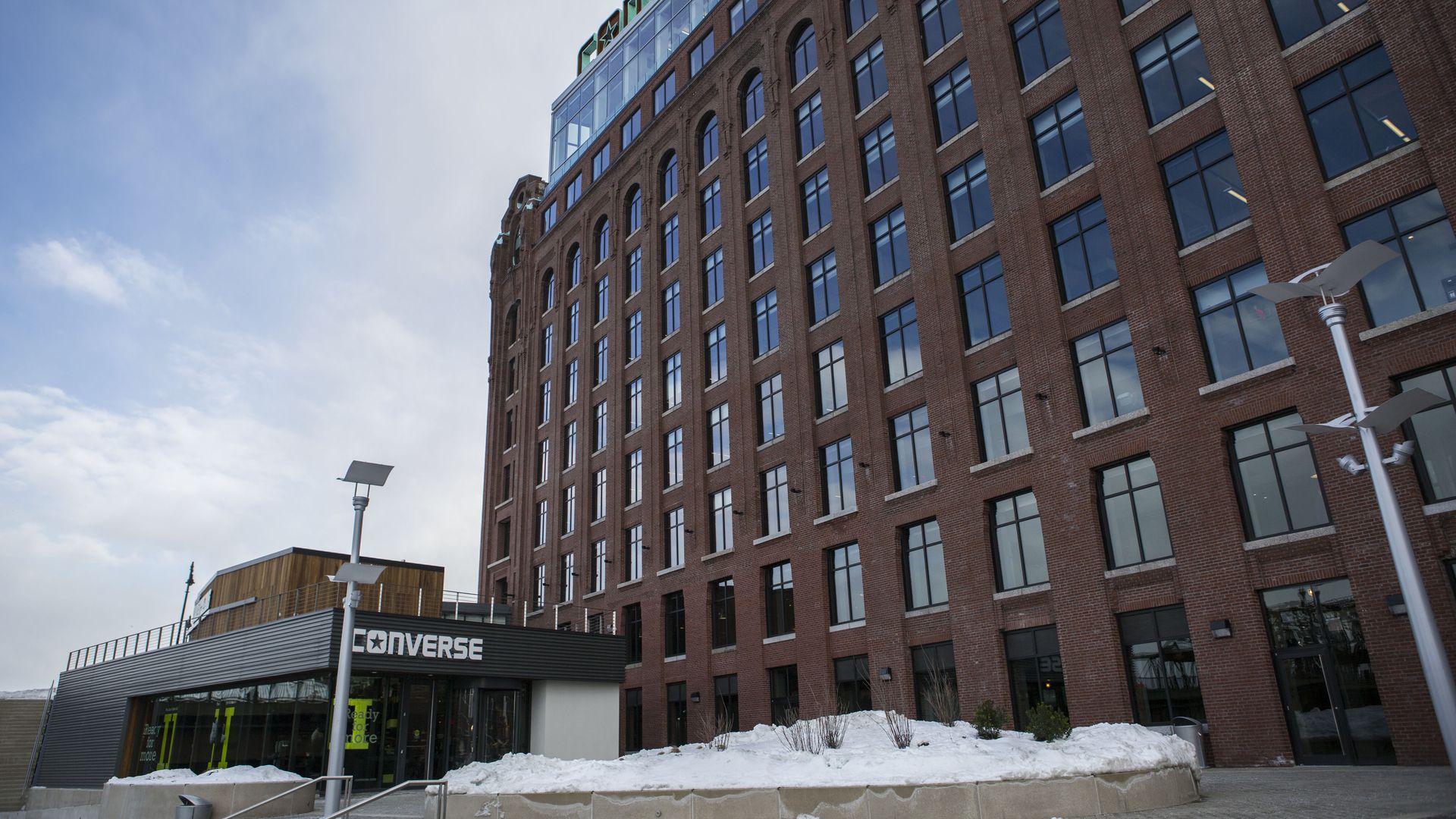 A wide shot showing the Converse Inc. headquarters at 1 Lovejoy Wharf in Boston in 2016. There's snow on the ground.