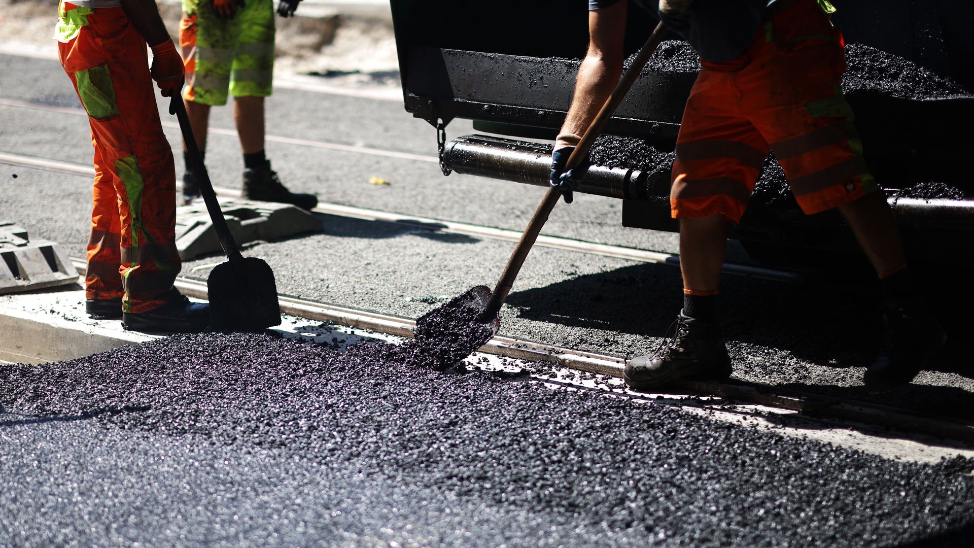 Workers laying asphalt