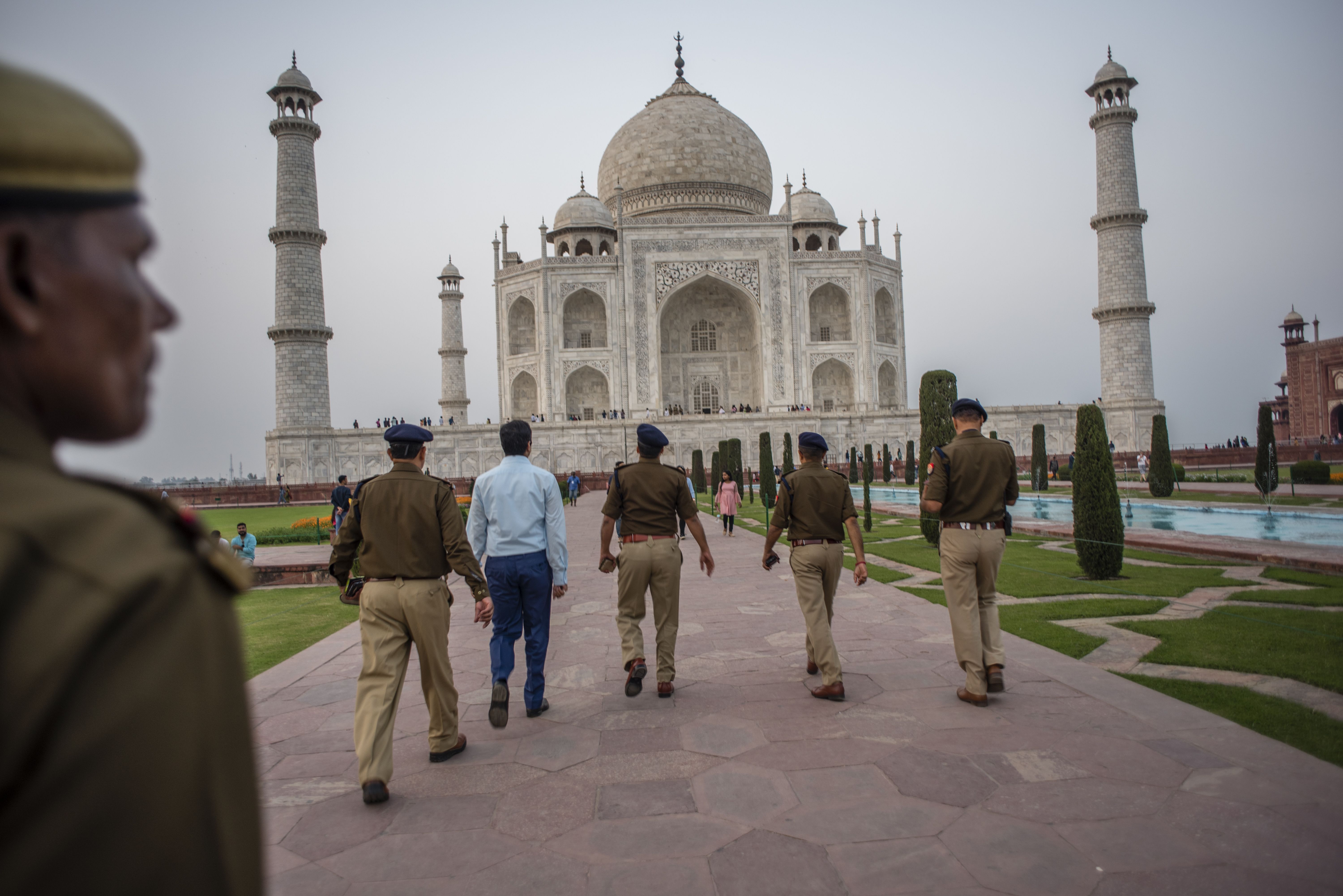  Indian police officers stand guard in the premises of the Taj Mahal on February 23, 2020 in Agra, India.
