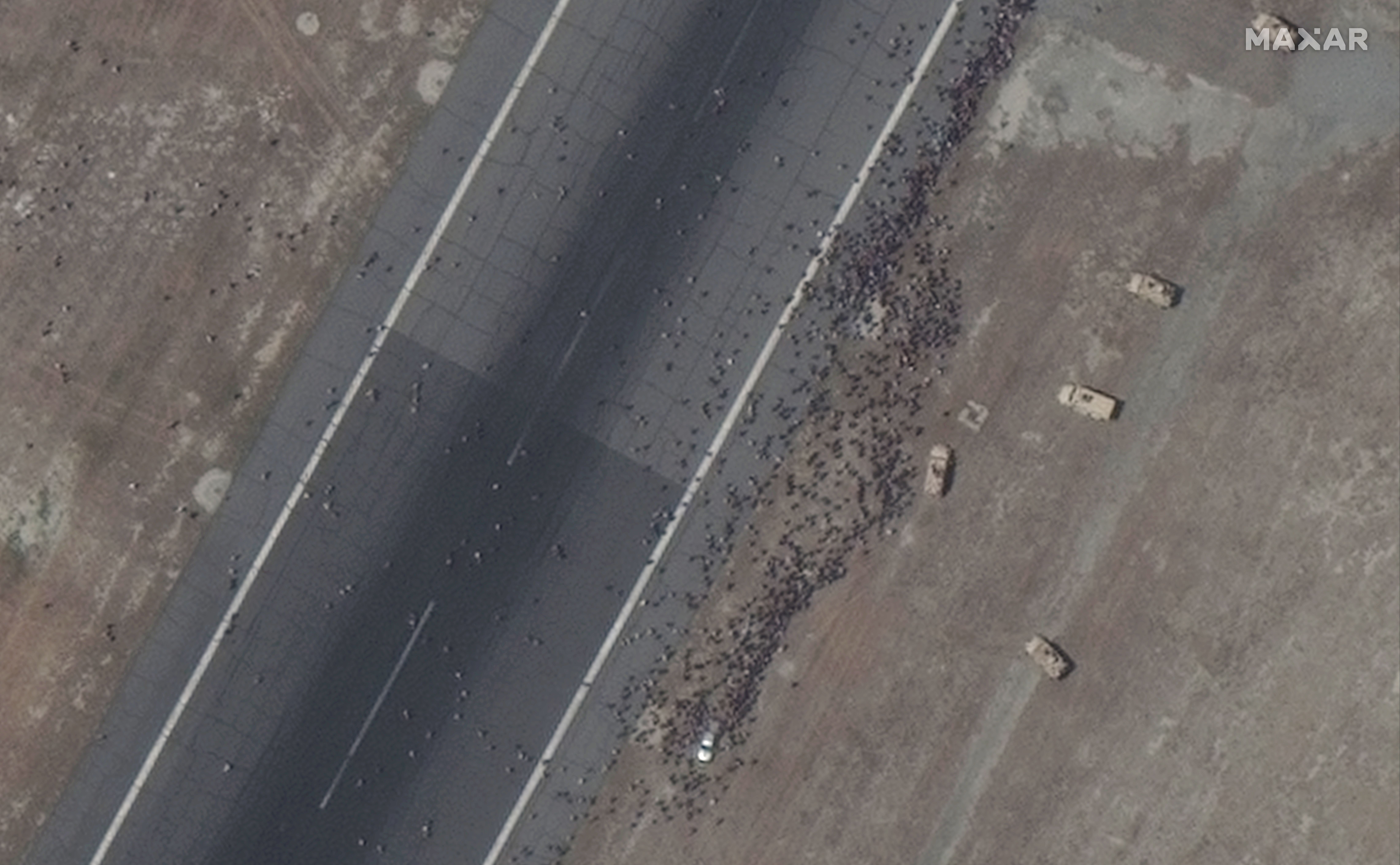 Close up view of crowds along the runway of the Kabul airport on Tuesday. Photo: Satellite image ©2021 Maxar Technologies    