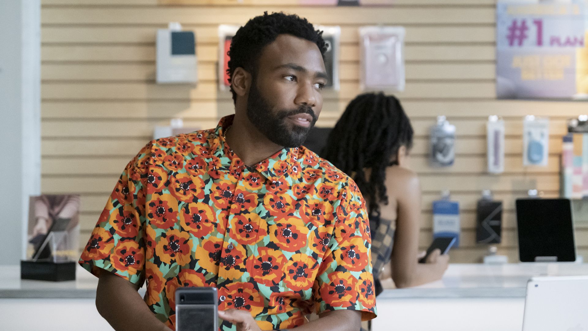 A photo of Donald Glover wearing a colorful shirt in a store on an episode of Atlanta