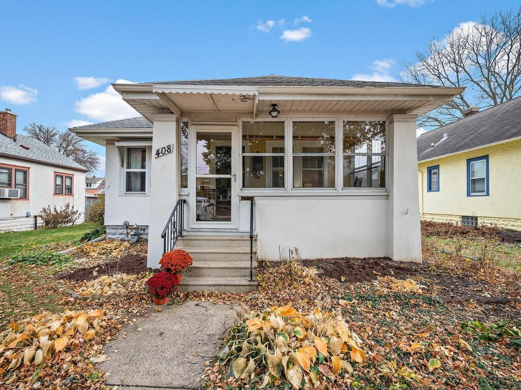 exterior of light colored bungalow with enclosed porch