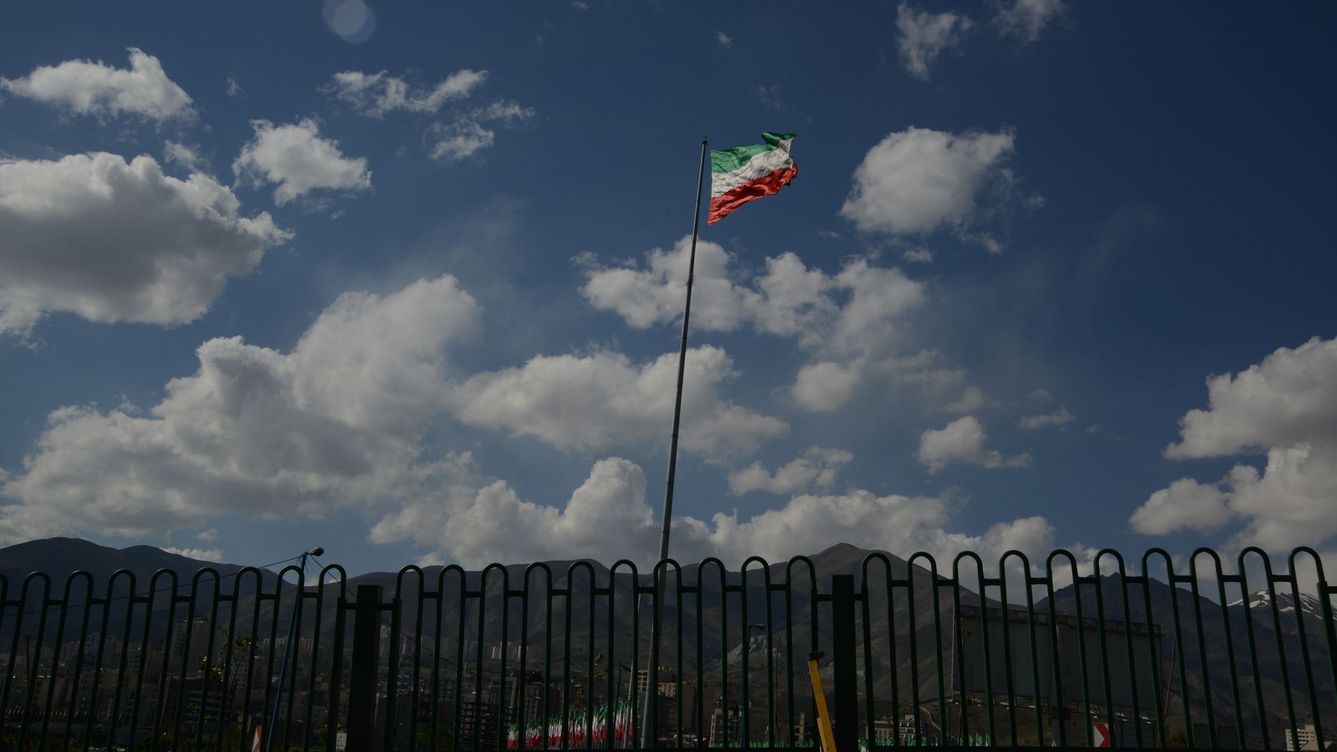 An Iranian flag seen amass against the cloudy blue sky on April 22, 2013 in Tehran, Iran. 