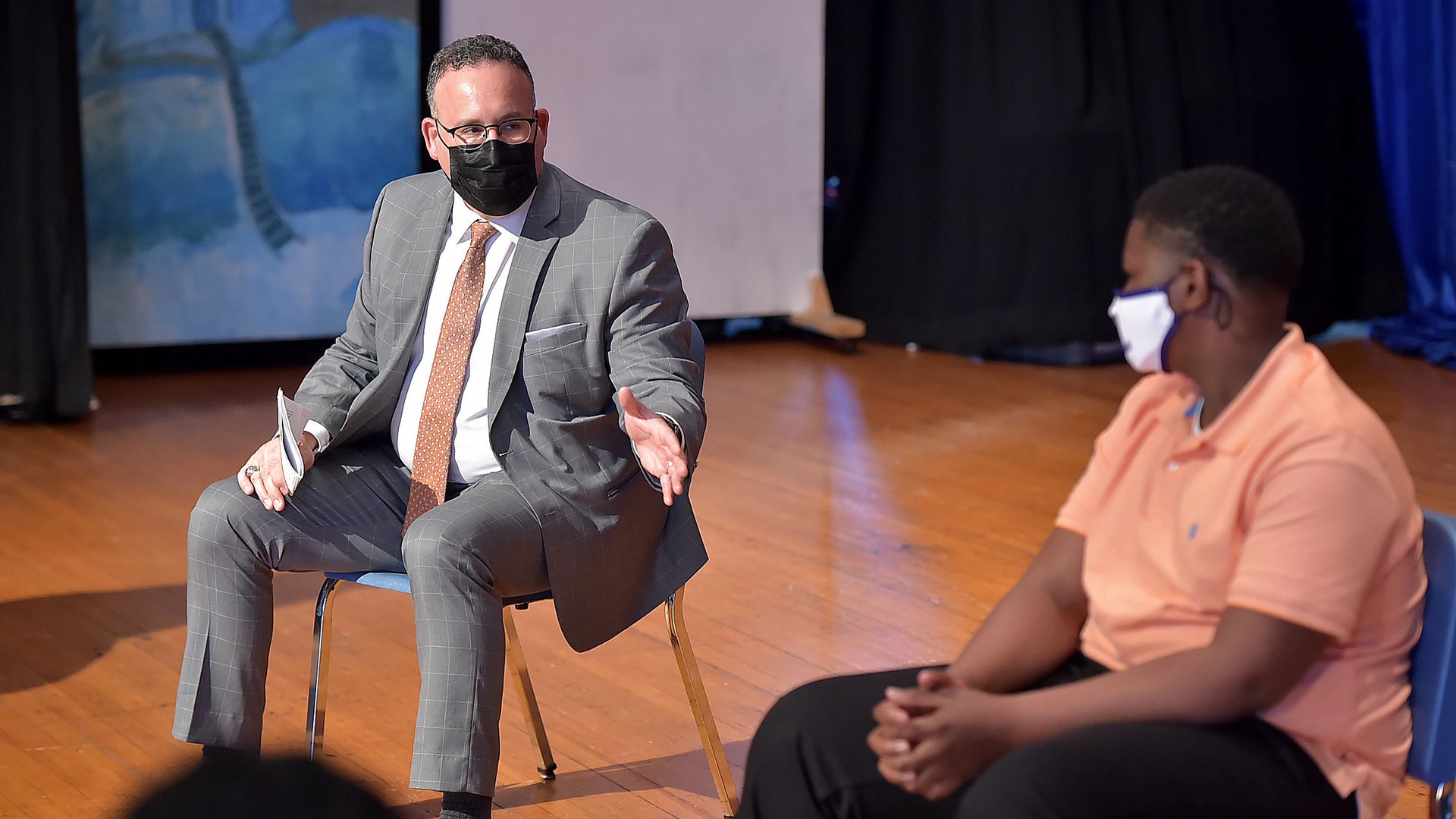 Education Secretary Cardona sits in a chair