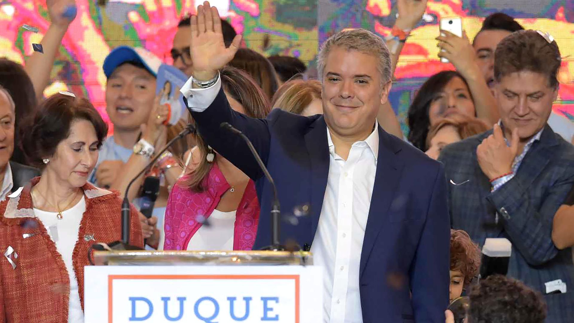 Ivan Duque waves to a crowd of supporters