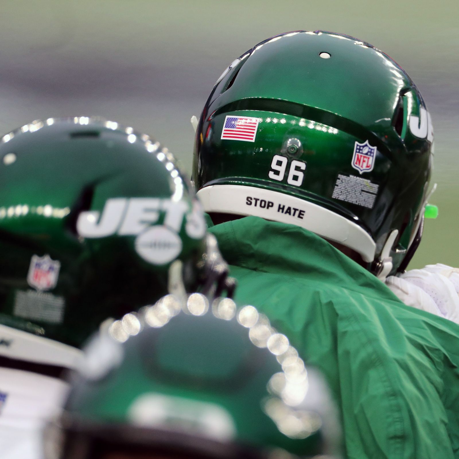 Why do NFL helmets have 'It Takes All of Us' written on them?