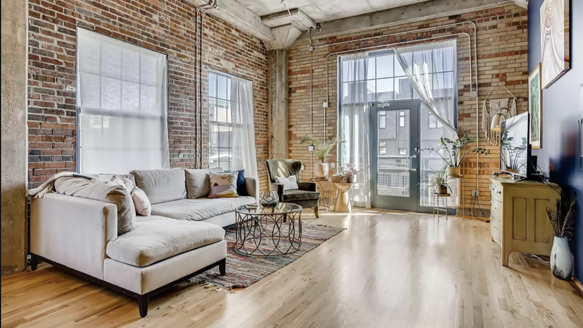 The inside of a condo in the iconic Benjamin Moore building with 14-foot ceilings, exposed brick walls, open layout and a walkable location.