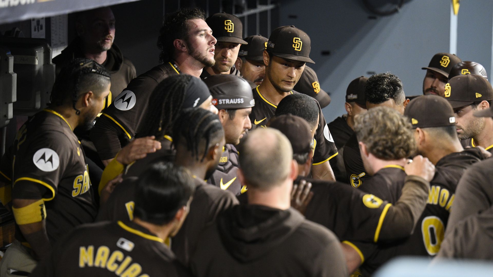 Padres players gather in the dugout during the 8th inning of a win in Dodger Stadium.
