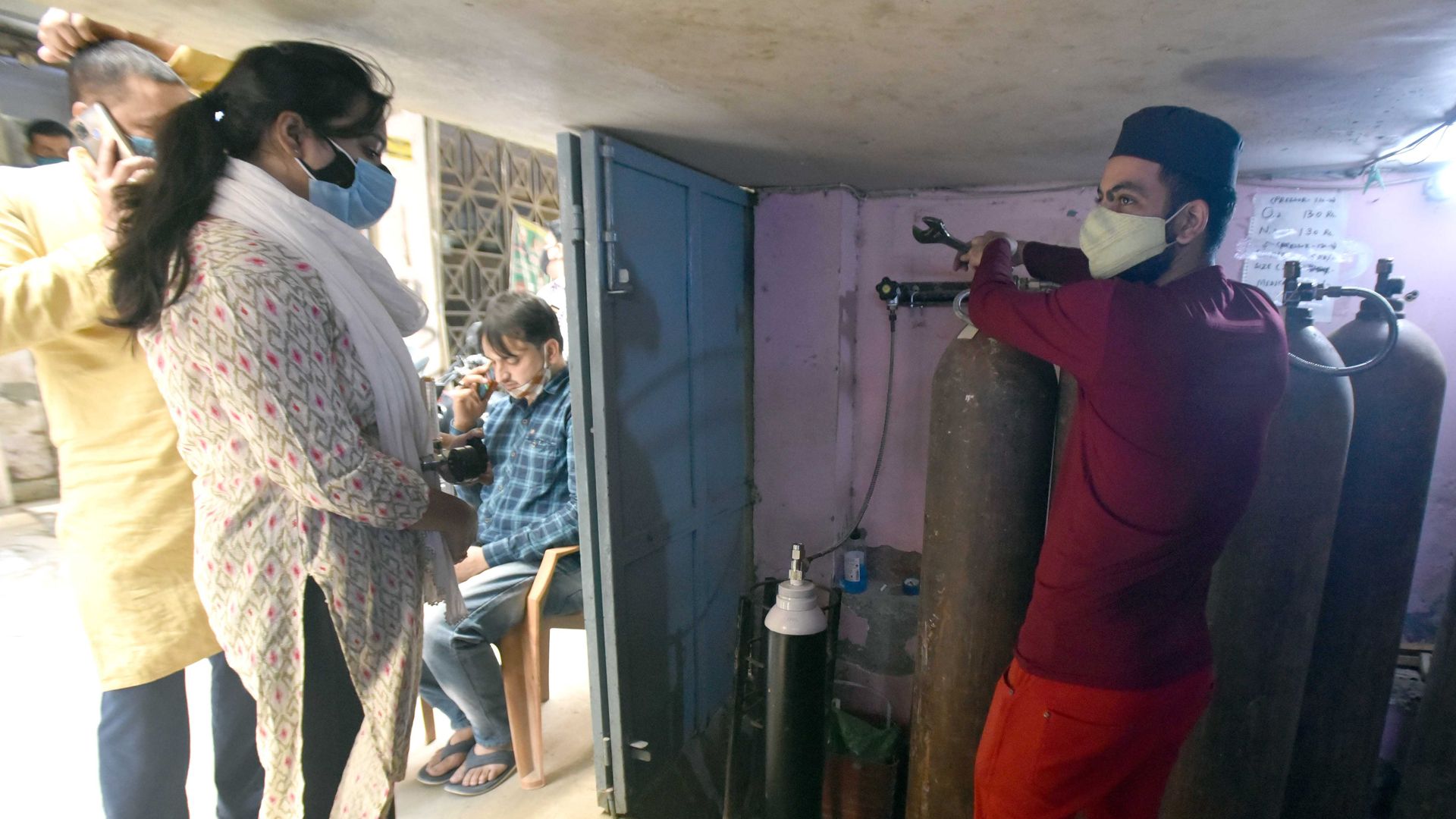 People filing the oxygen cylinders for housed patients at Shaheen Bagh on April 21, 2021 in New Delhi, India.