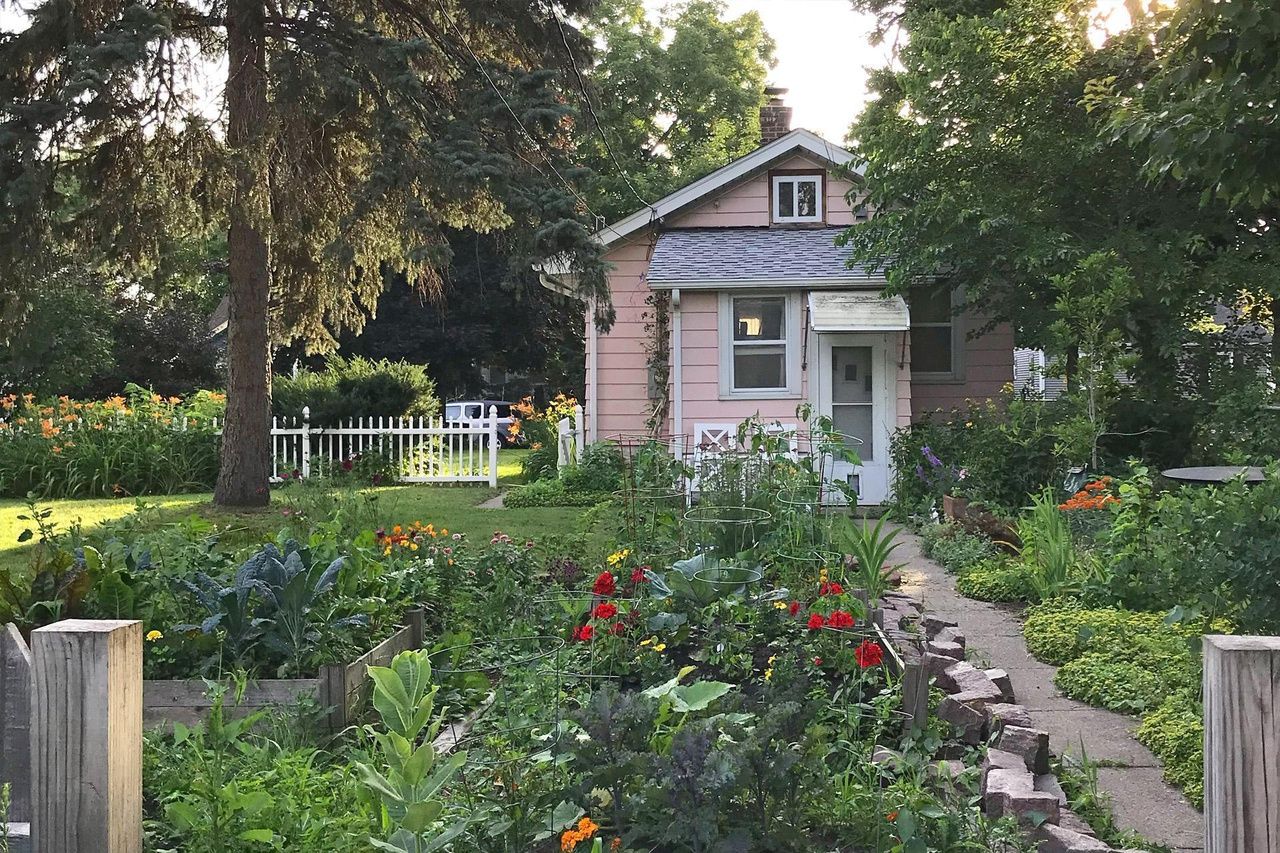 lush lot with gardens surrounding tiny home