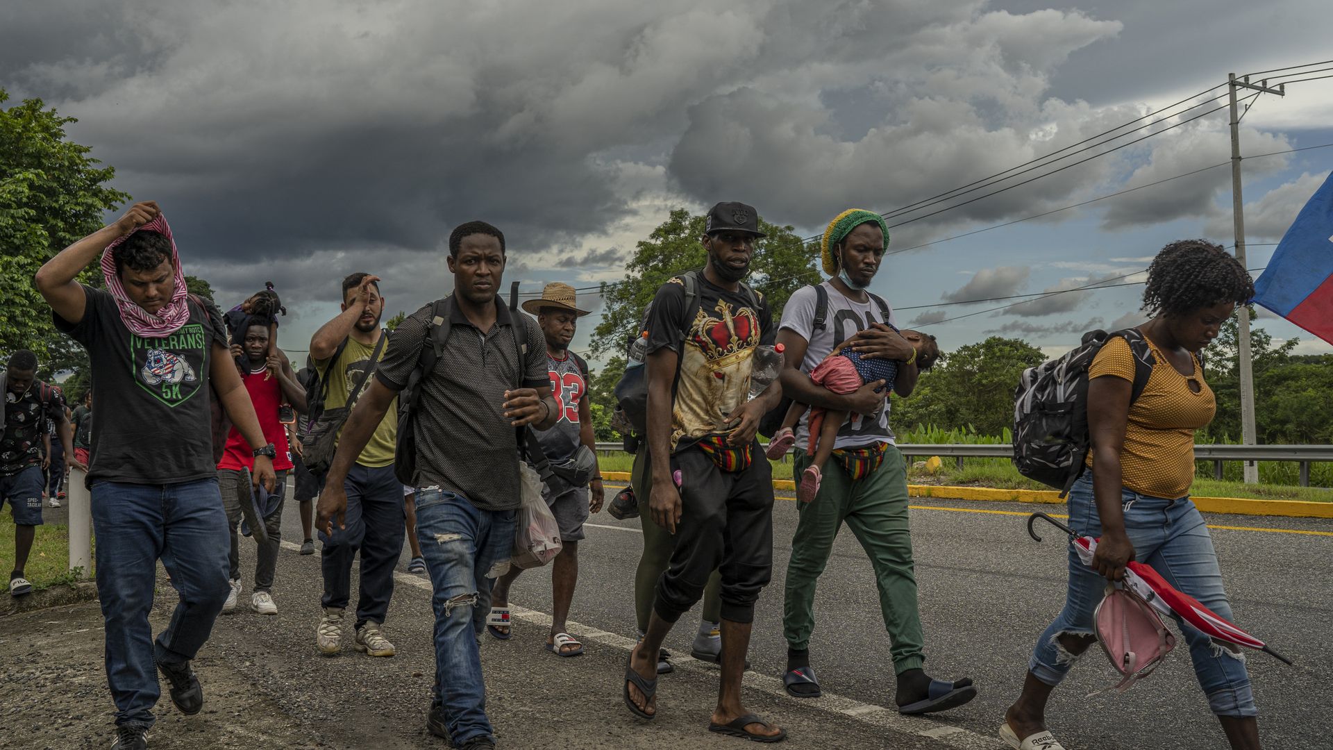 Haitian migrants walk along a highway in Tapachula, Chiapas state, Mexico, on Wednesday, Sept. 1, 2021
